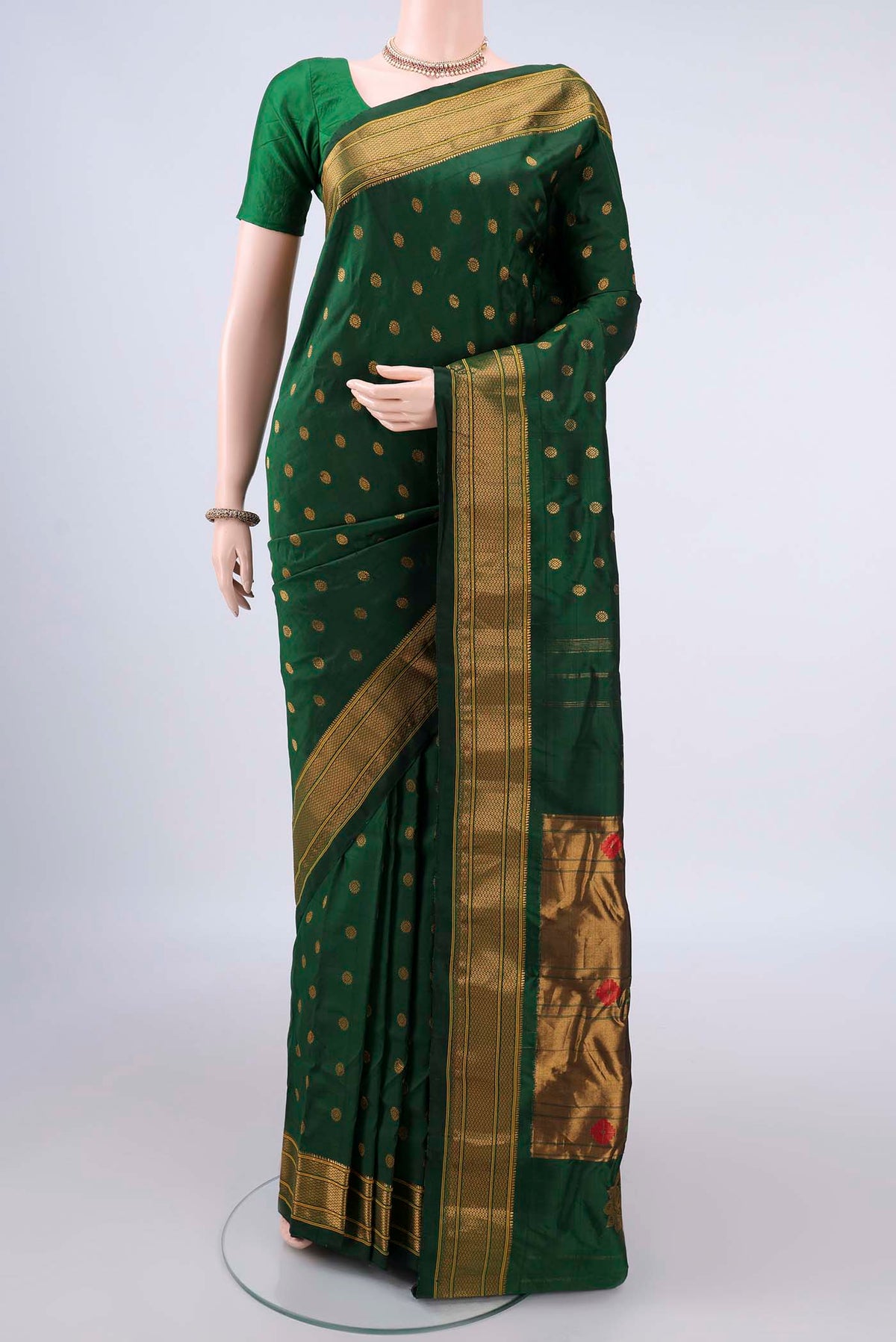 Pure Silk Bottle Green Gadwal Saree with Zari Butta on the body and Zari Border.  displayed on a mannequin