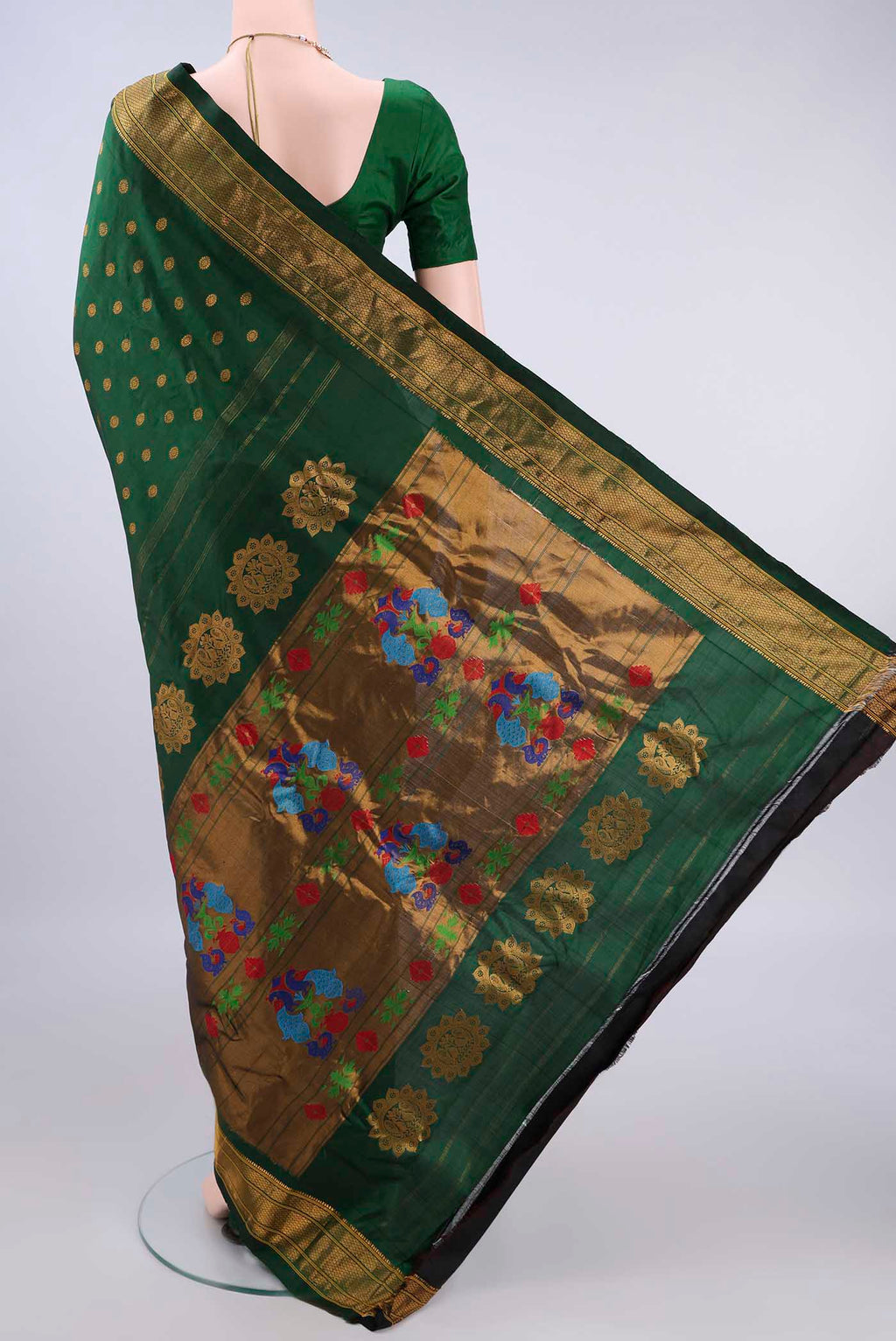 Flat view of Pure Silk Bottle Green Gadwal Saree with Zari Butta on the body and Zari Border. 