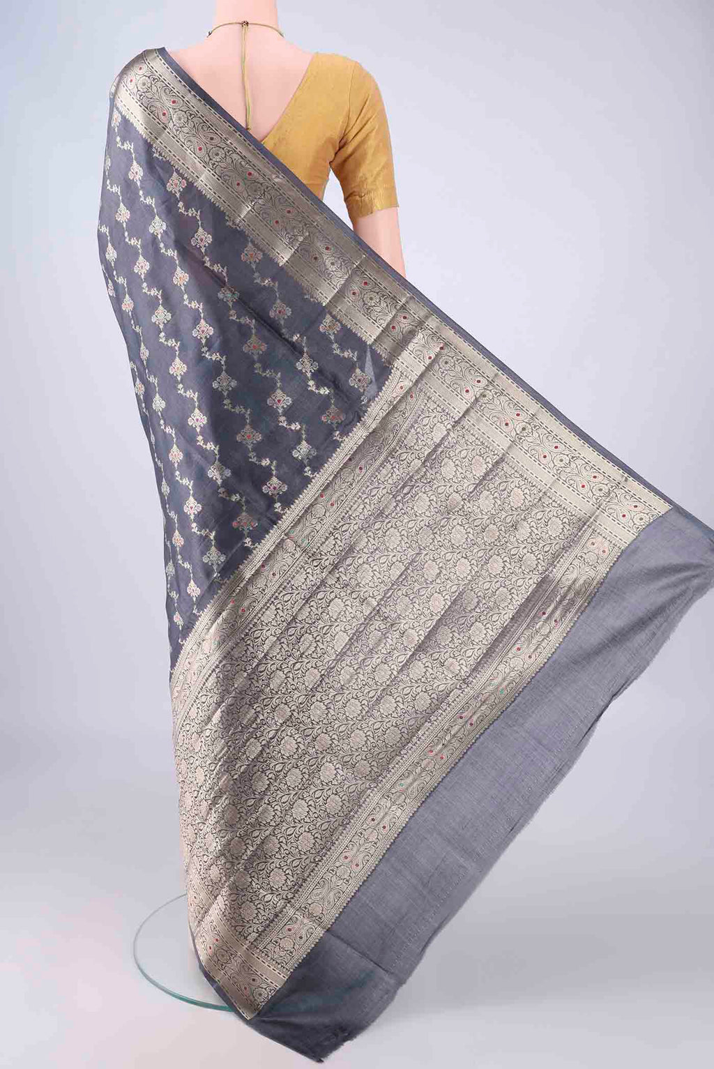 Flat view of Grey Banarasi Tussar Silk Saree with Zari Brocade on the body and Zari Border. 
