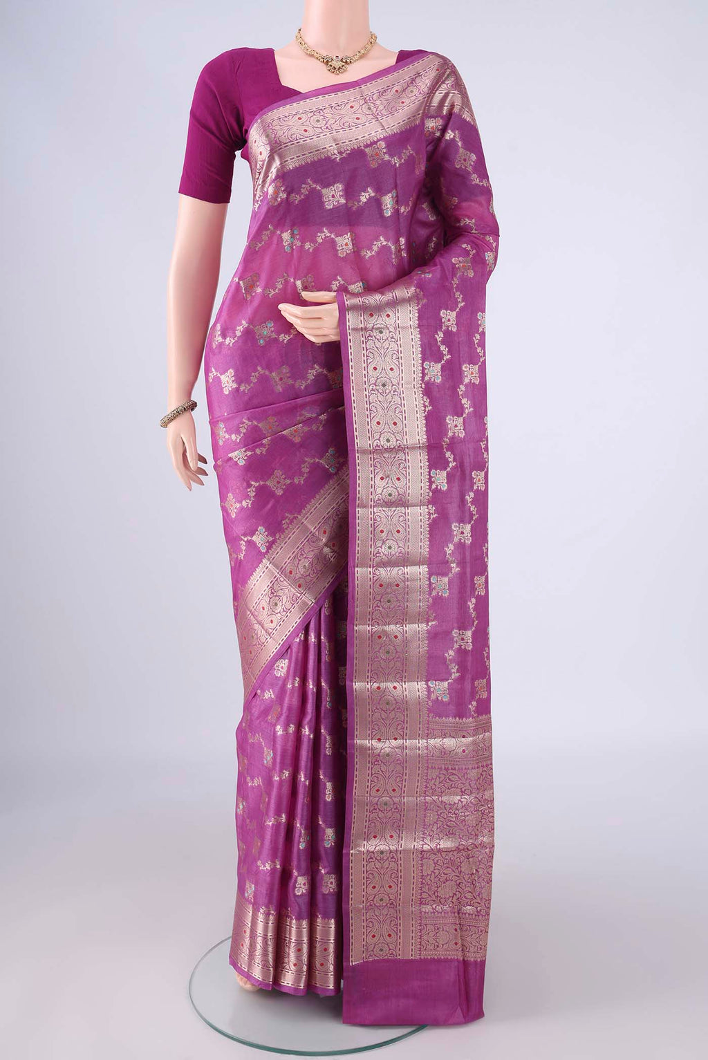 Magenta Banarasi Tussar Silk Saree with Zari And Thread Butta on the body and Zari Border.  displayed on a mannequin
