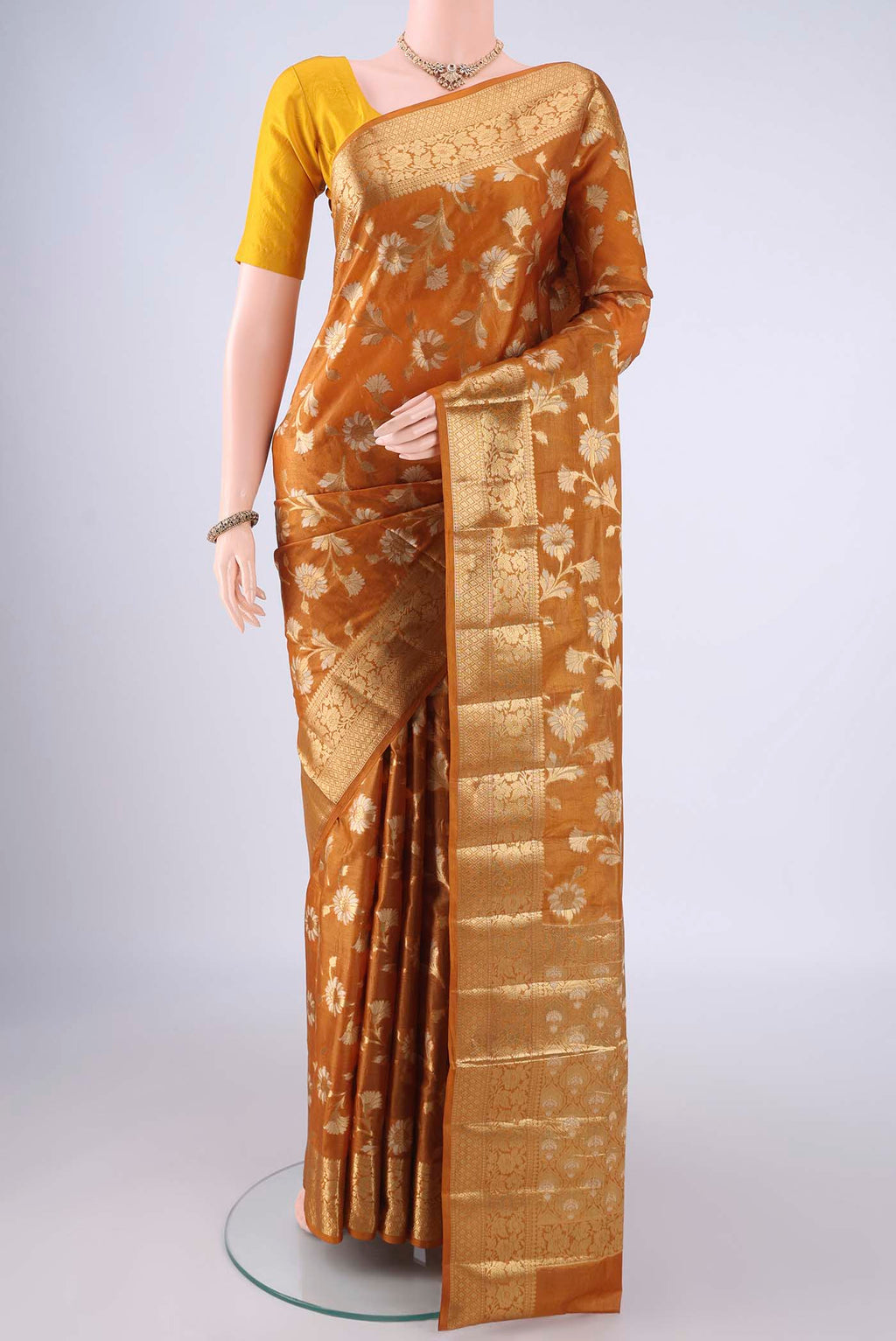 Mustard Banarasi Tussar Silk Saree with Zari And Thread Butta on the body and Zari Border.  displayed on a mannequin