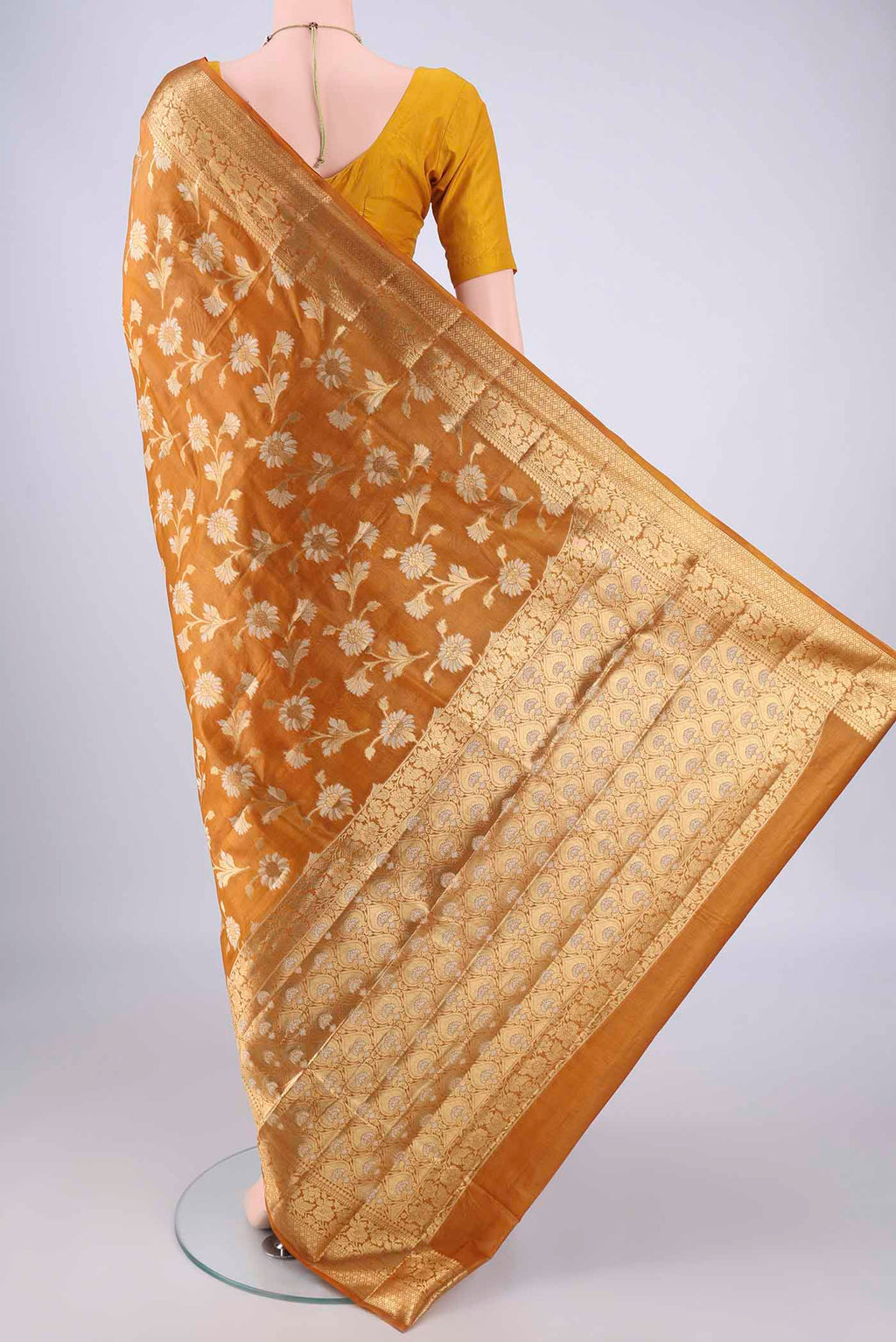Flat view of Mustard Banarasi Tussar Silk Saree with Zari And Thread Butta on the body and Zari Border. 
