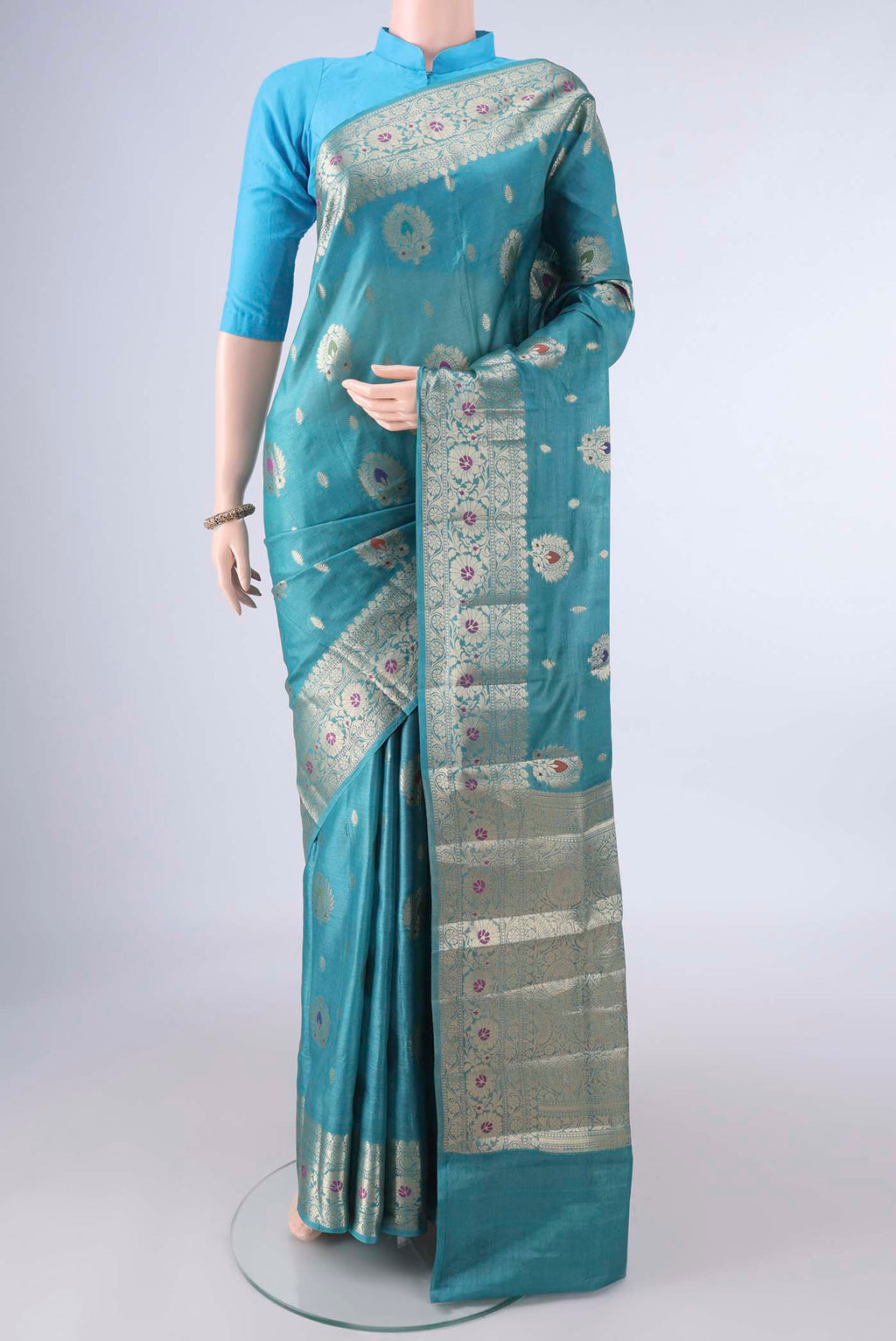 Sea Green Banarasi Tussar Saree with Zari And Thread Butta on the body and Zari Border.  displayed on a mannequin