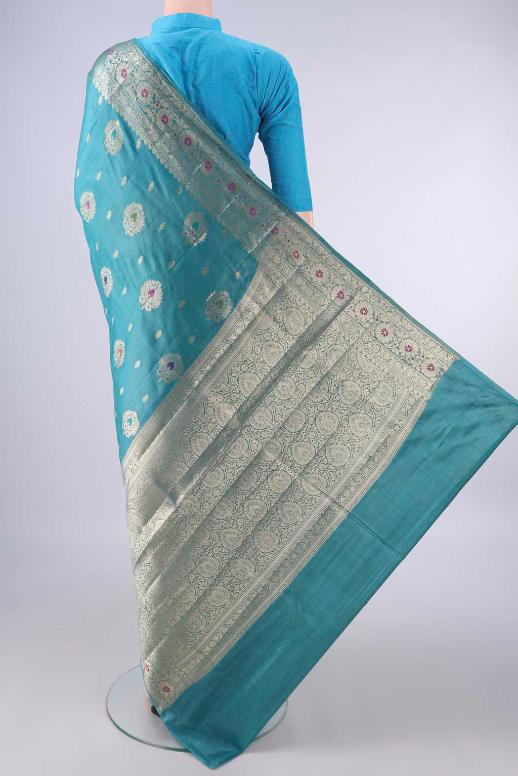 Flat view of Sea Green Banarasi Tussar Saree with Zari And Thread Butta on the body and Zari Border. 