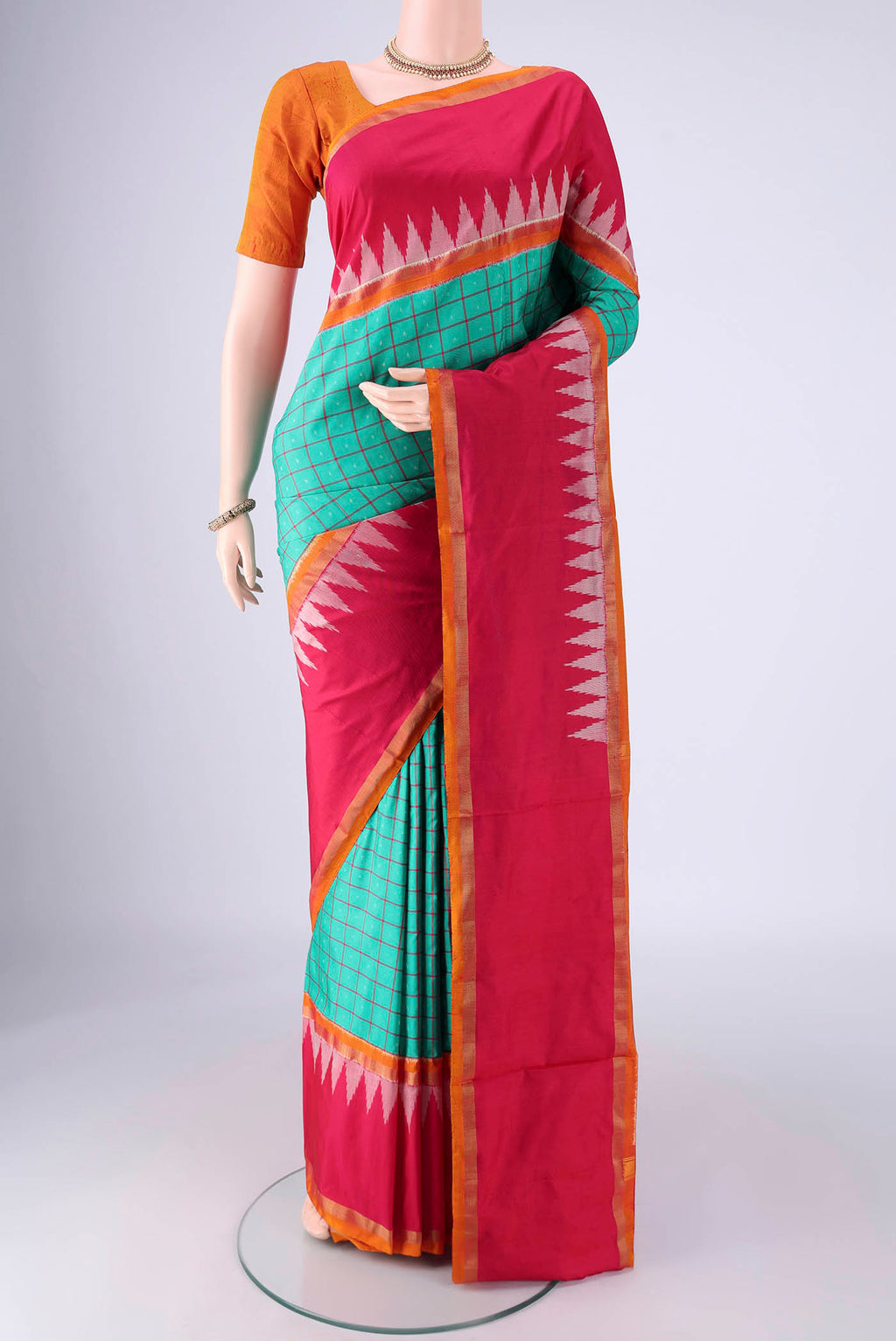 Sea Green Pochampally Silk Saree with Checked design on the body and Temple Border.  displayed on a mannequin