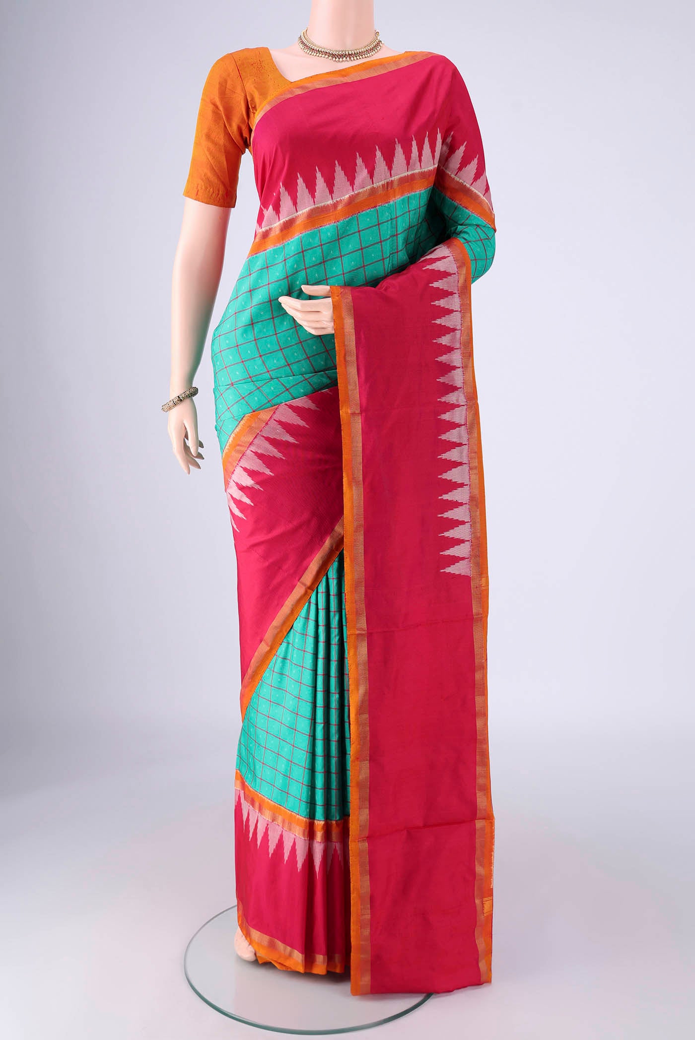 Sea Green Pochampally Silk Saree with Checked design on the body and Temple Border.  displayed on a mannequin