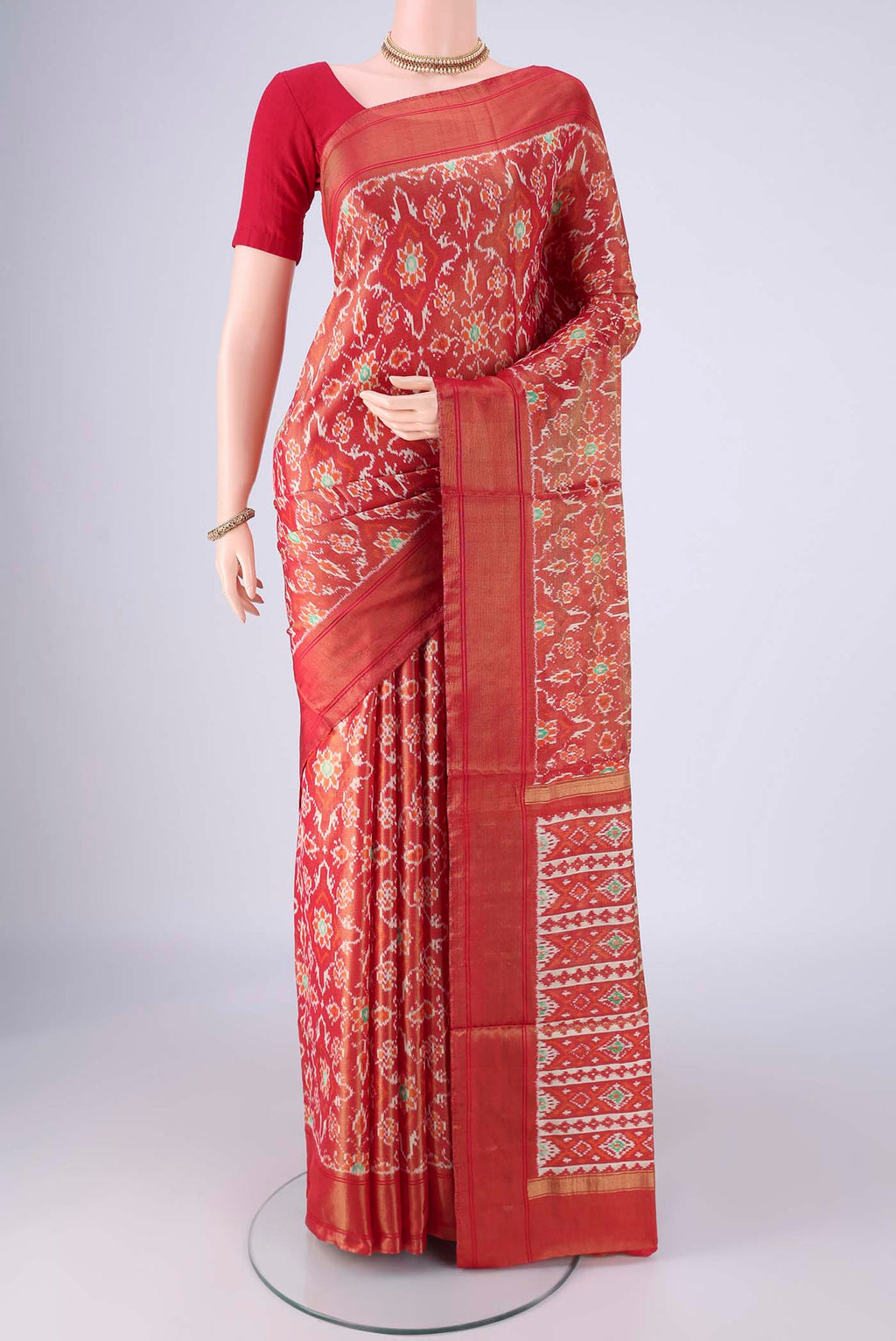 Red Pochampally Silk Saree with Ikat design on the body and Zari Border.  displayed on a mannequin