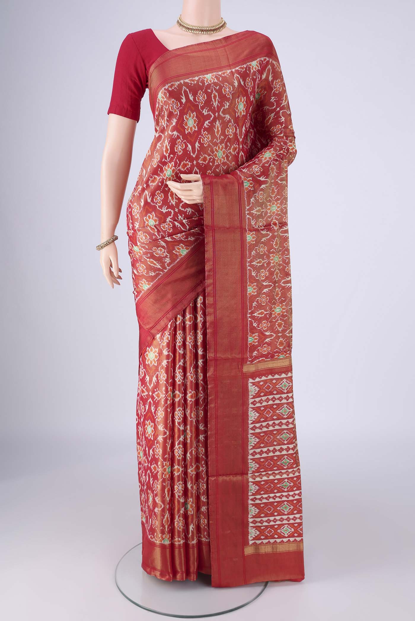 Red Pochampally Silk Saree with Ikat design on the body and Zari Border.  displayed on a mannequin