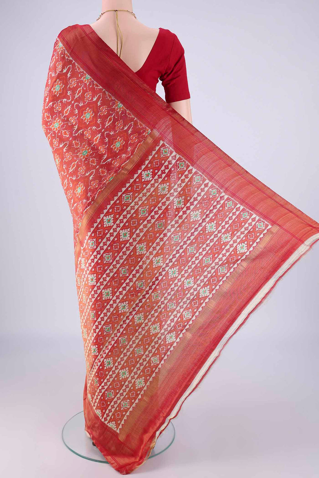 Flat view of Red Pochampally Silk Saree with Ikat design on the body and Zari Border. 