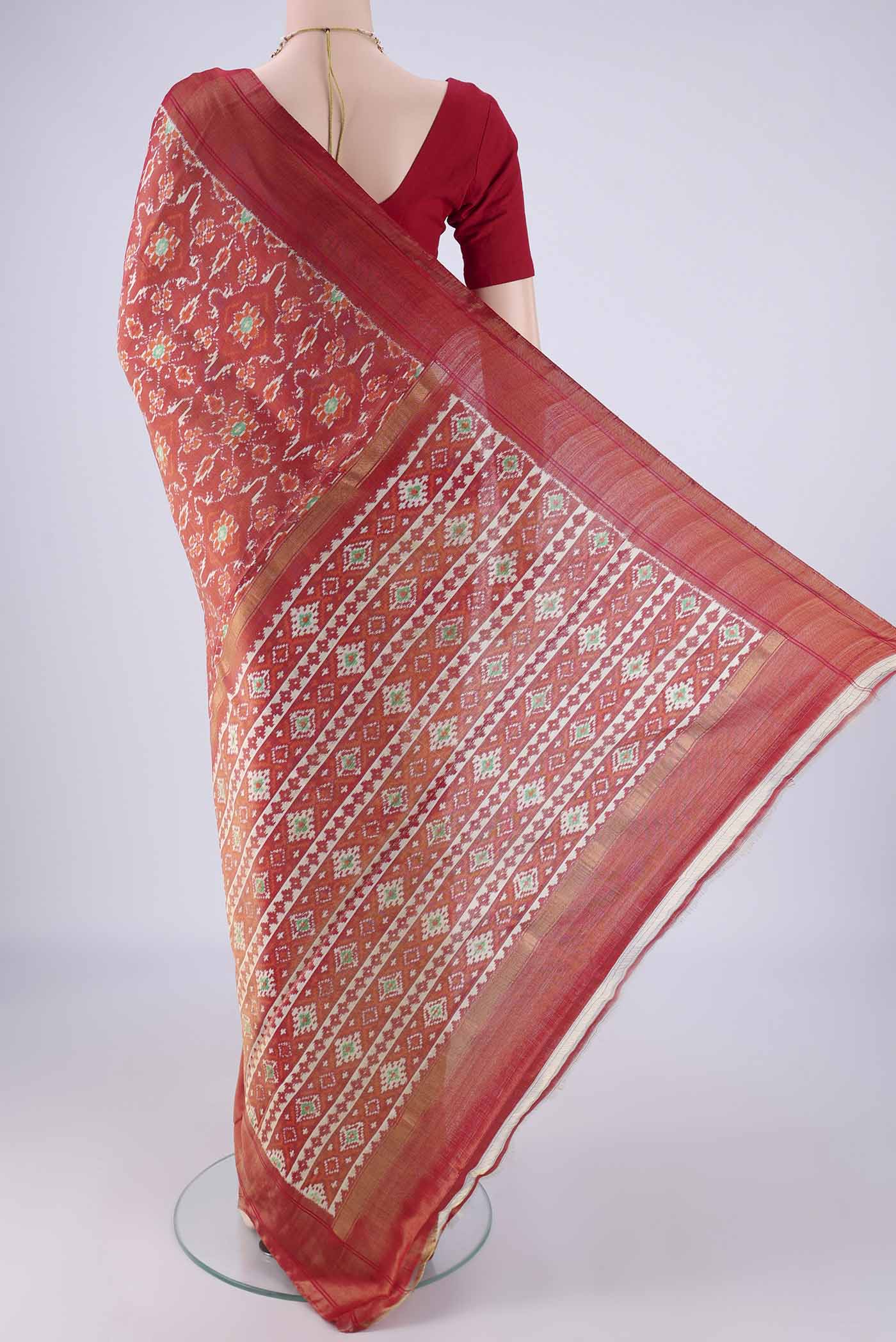 Flat view of Red Pochampally Silk Saree with Ikat design on the body and Zari Border. 