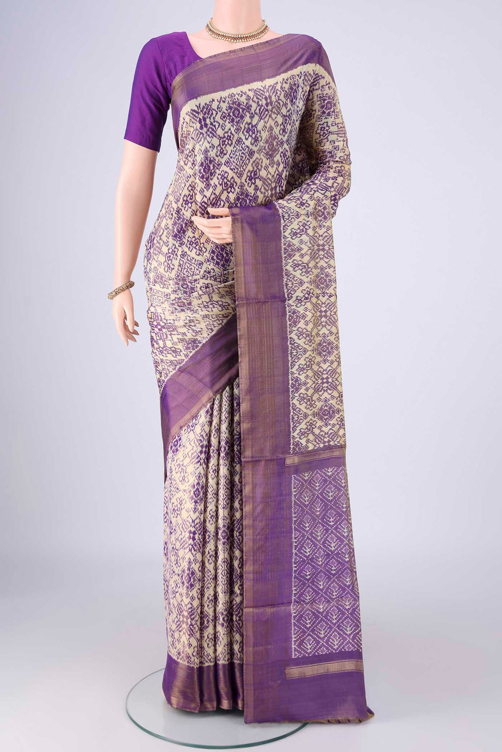 Off White Pochampally Silk Saree with Ikat design on the body and Zari Border.  displayed on a mannequin