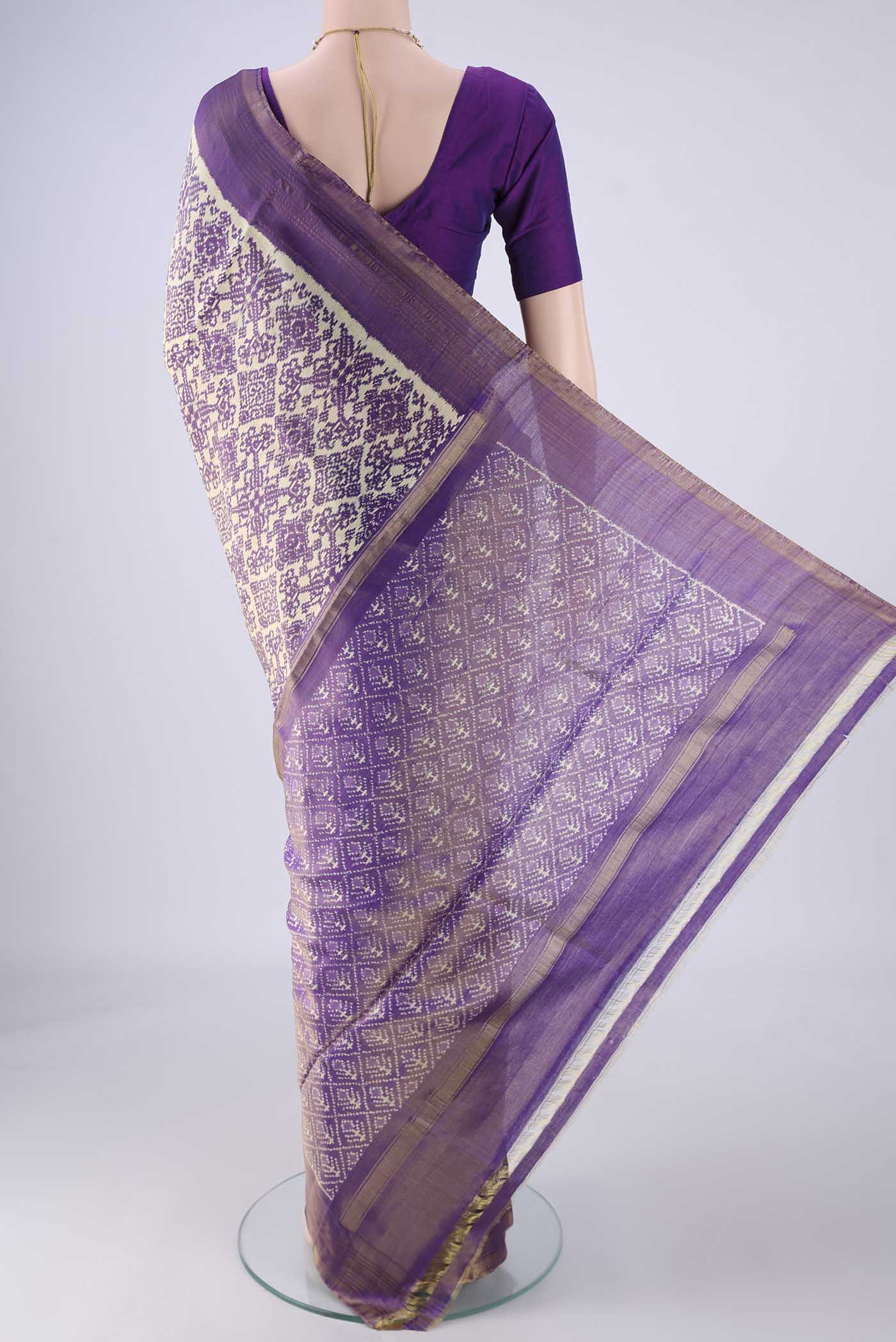 Flat view of Off White Pochampally Silk Saree with Ikat design on the body and Zari Border. 