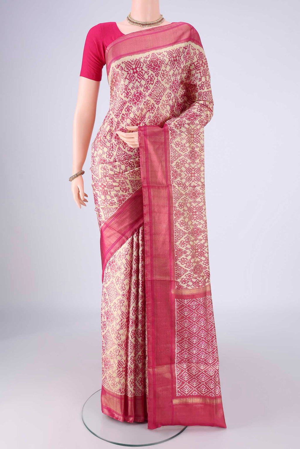 Off White Pochampally Silk Saree with Ikat design on the body and Zari Border.  displayed on a mannequin