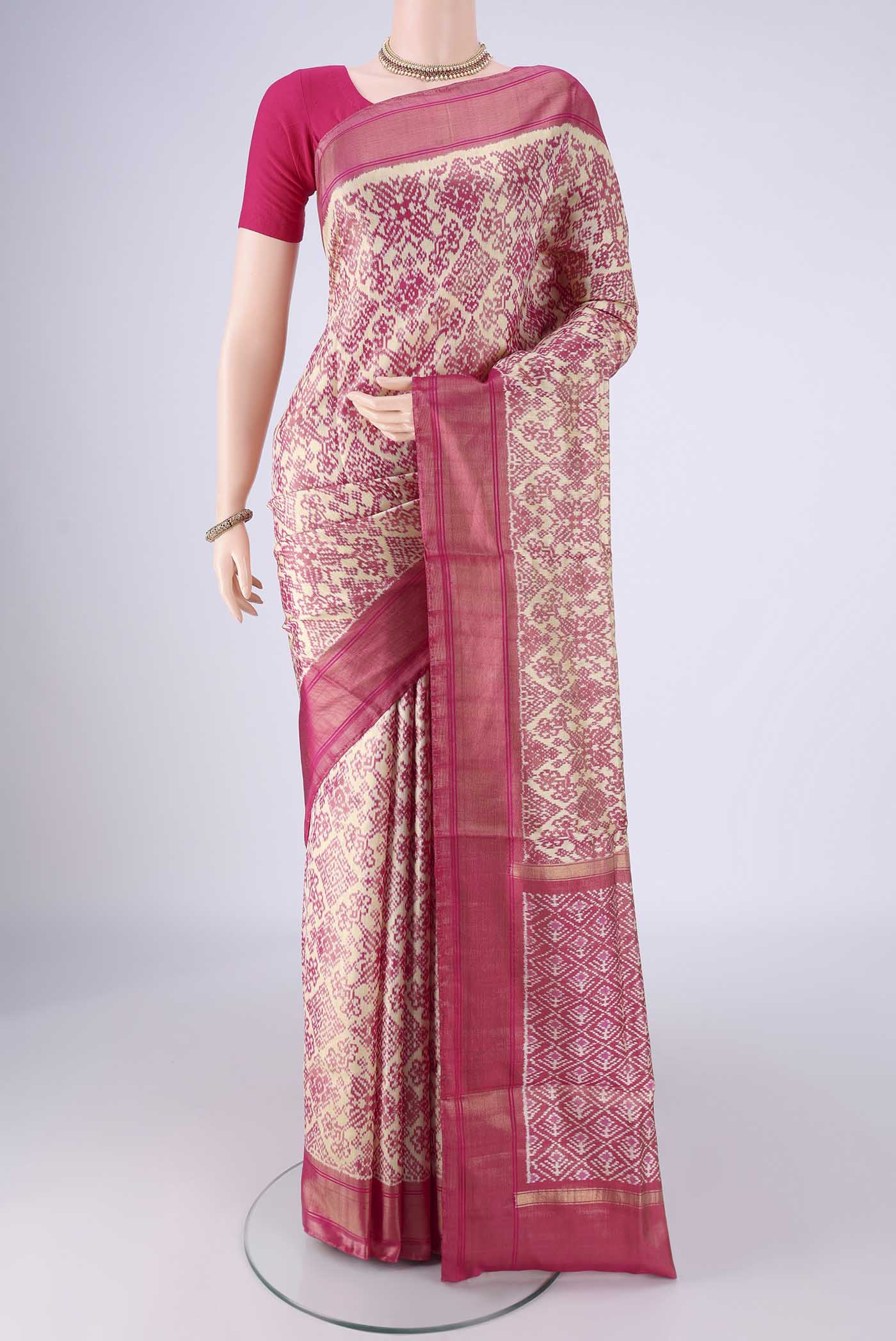 Off White Pochampally Silk Saree with Ikat design on the body and Zari Border.  displayed on a mannequin