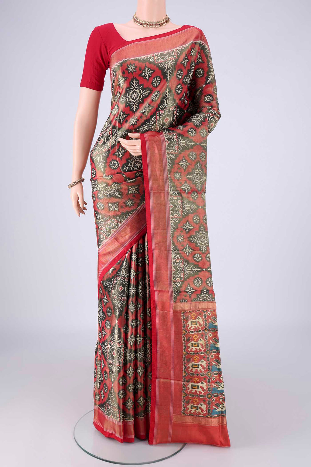 Grey Pochampally Silk Saree with Ikat design on the body and Zari Border.  displayed on a mannequin