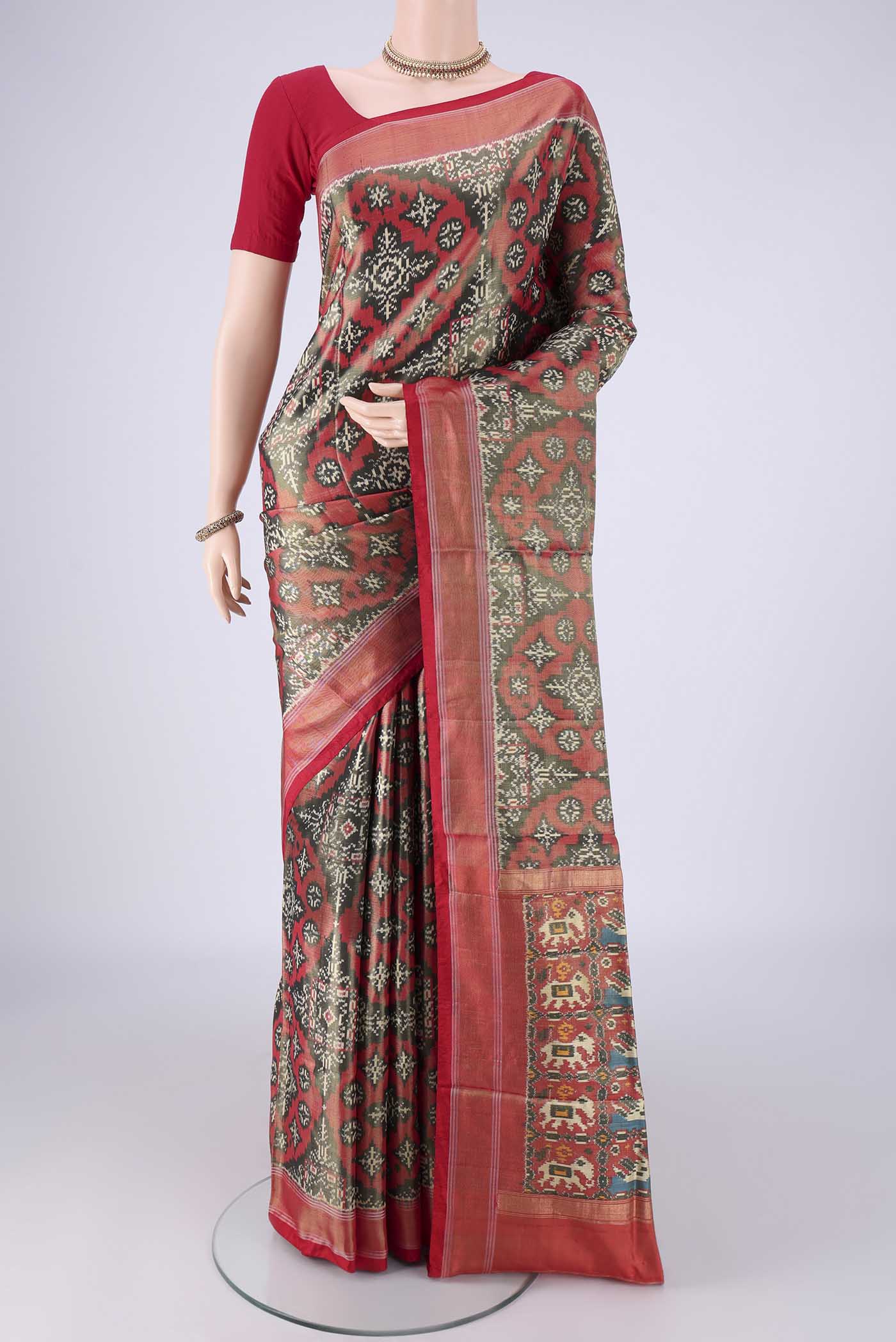 Grey Pochampally Silk Saree with Ikat design on the body and Zari Border.  displayed on a mannequin