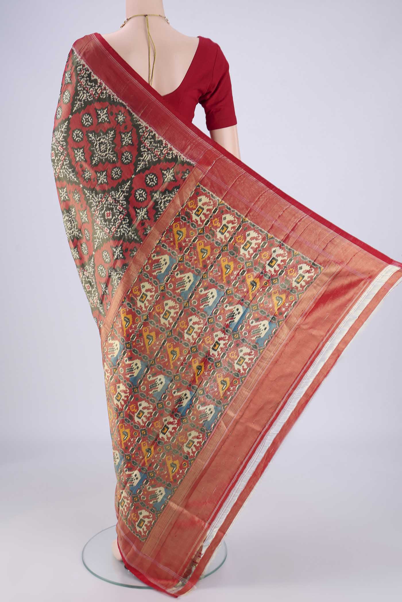 Flat view of Grey Pochampally Silk Saree with Ikat design on the body and Zari Border. 