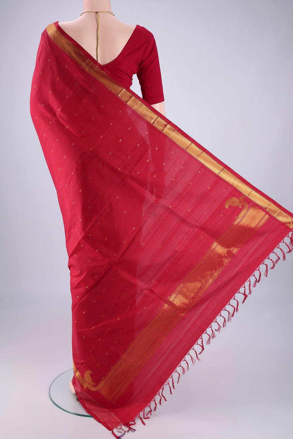 Flat view of Red Kanchipuram Silk Saree with Zari Butta on the body and Zari Border. 