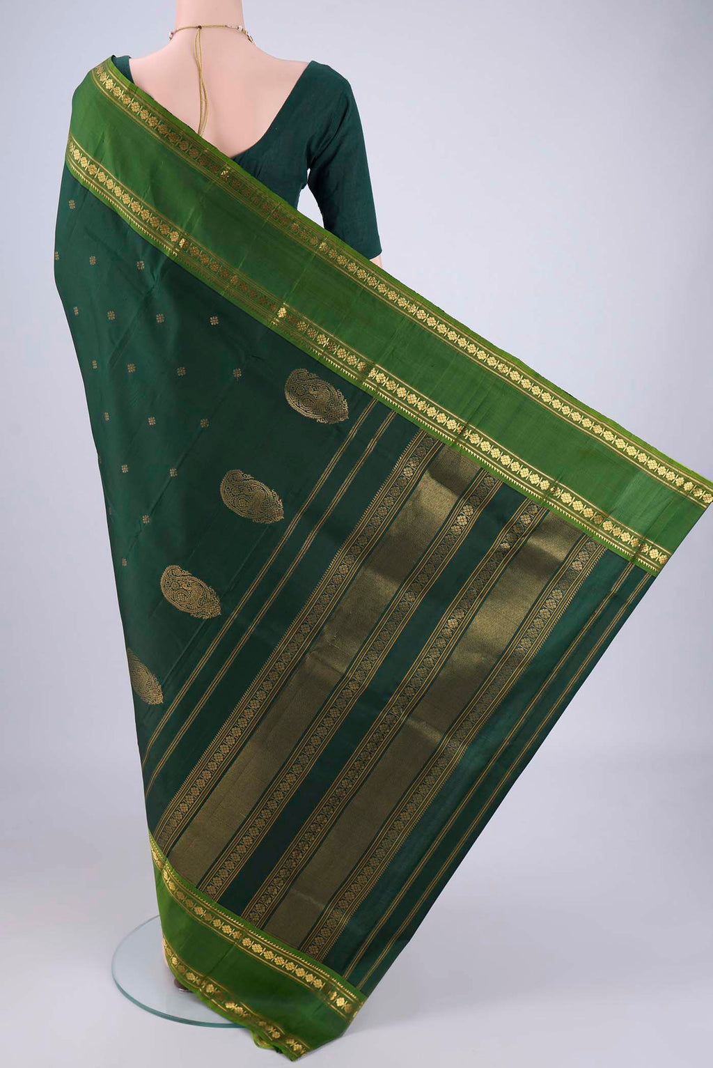 Flat view of Bottle Green Kanchipuram Silk Saree with Zari Butta on the body and Zari Border. 