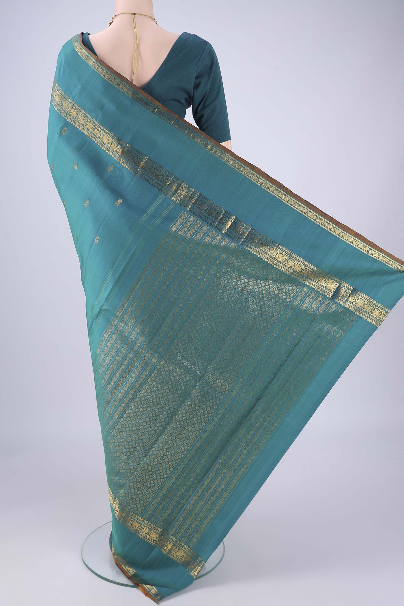 Flat view of Sea Green Kanjivaram Silk Saree with Zari Butta on the body and Zari Border. 