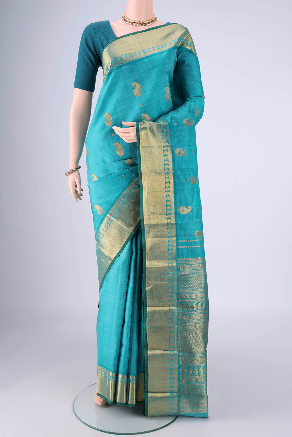 Blue Kanjivaram Silk Saree with Zari Butta on the body and Zari Border.  displayed on a mannequin