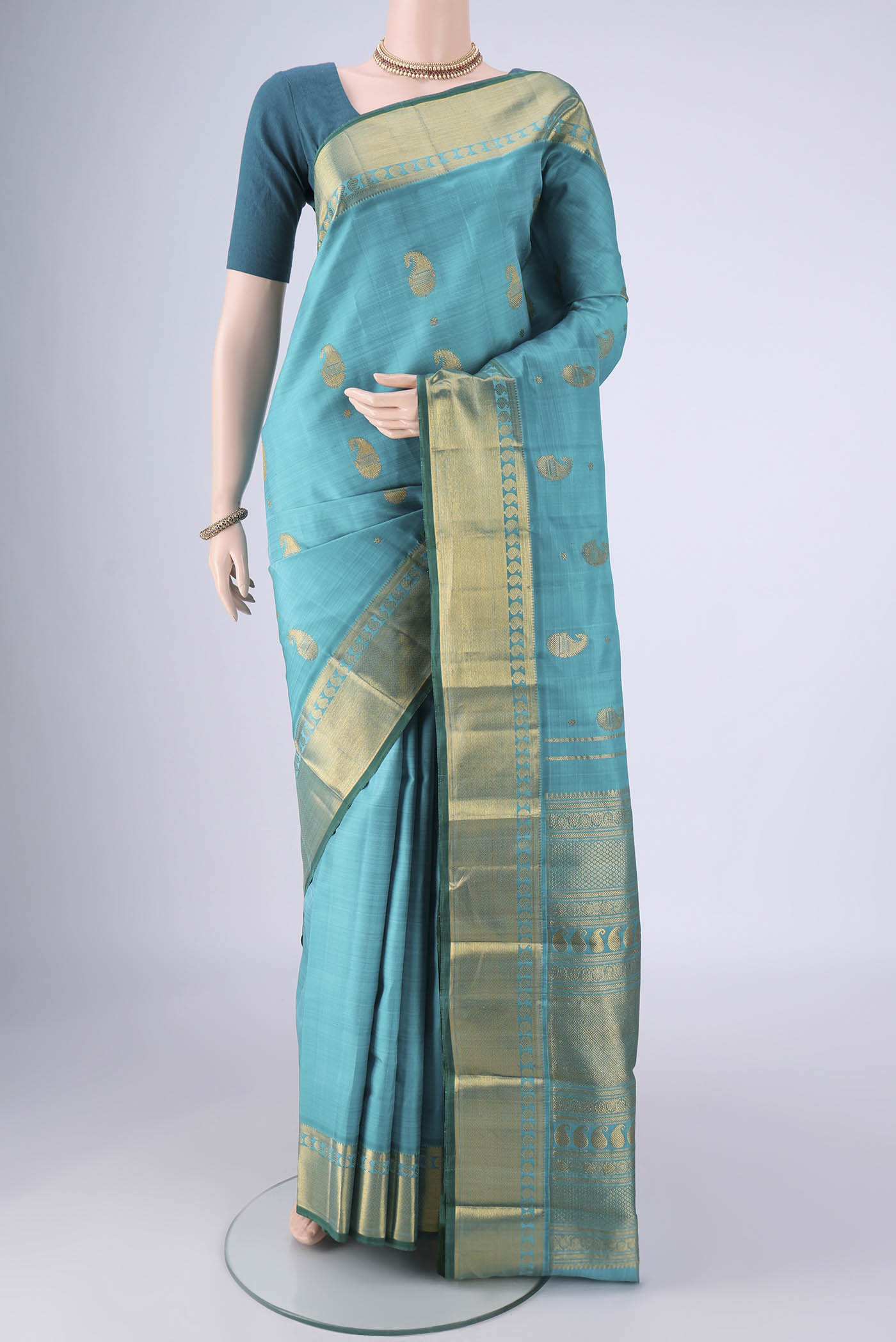Blue Kanjivaram Silk Saree with Zari Butta on the body and Zari Border.  displayed on a mannequin