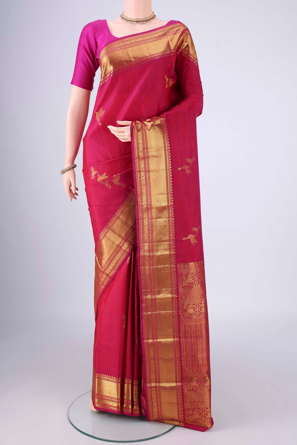 Dark Pink Kanjivaram Silk Saree with Zari Butta on the body and Zari Border.  displayed on a mannequin
