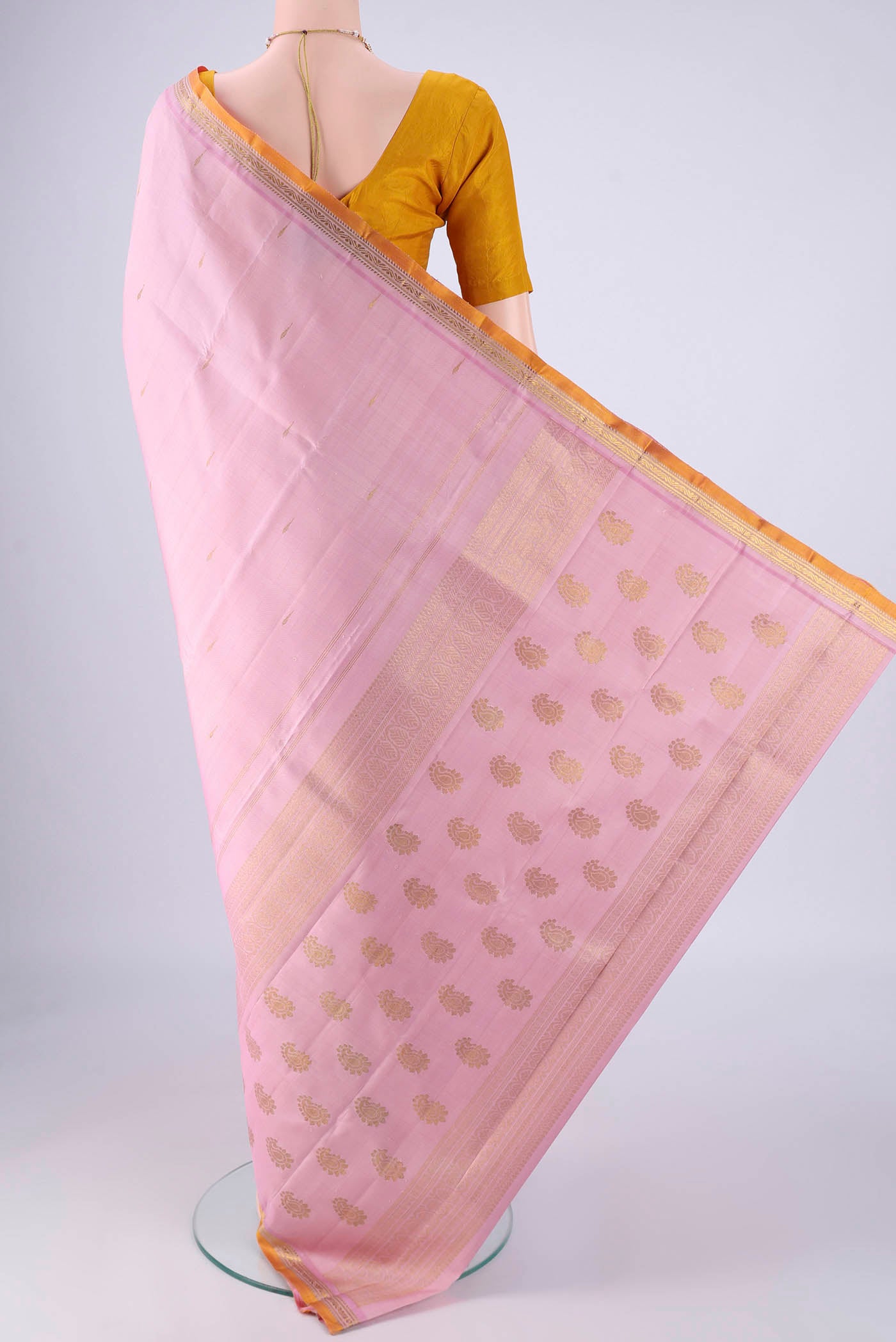 Flat view of Rose pink Kanjivaram Silk Saree with Zari Butta on the body and Zari Border. 