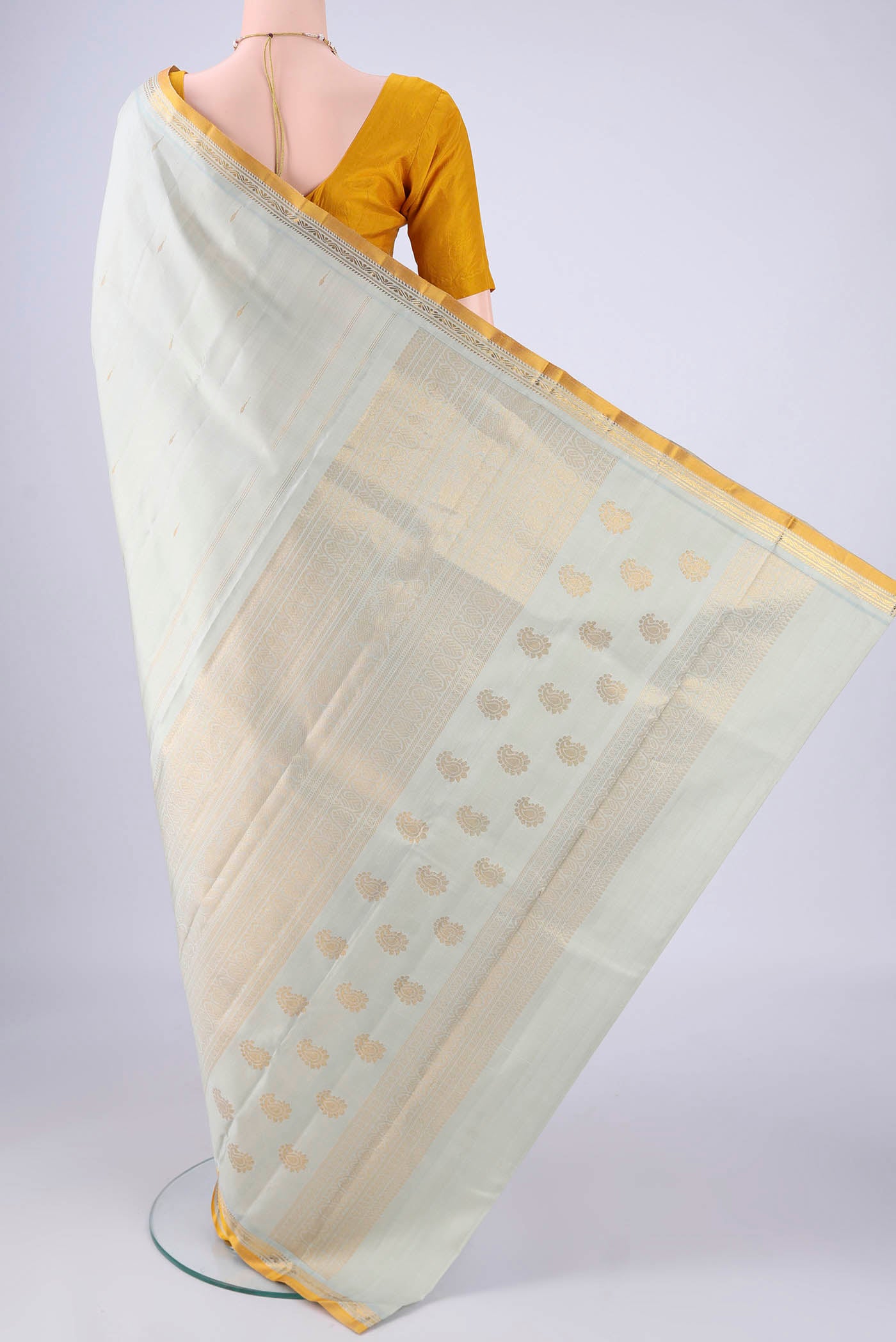 Flat view of Light Green Kanjivaram Silk Saree with Zari Butta on the body and Zari Border. 