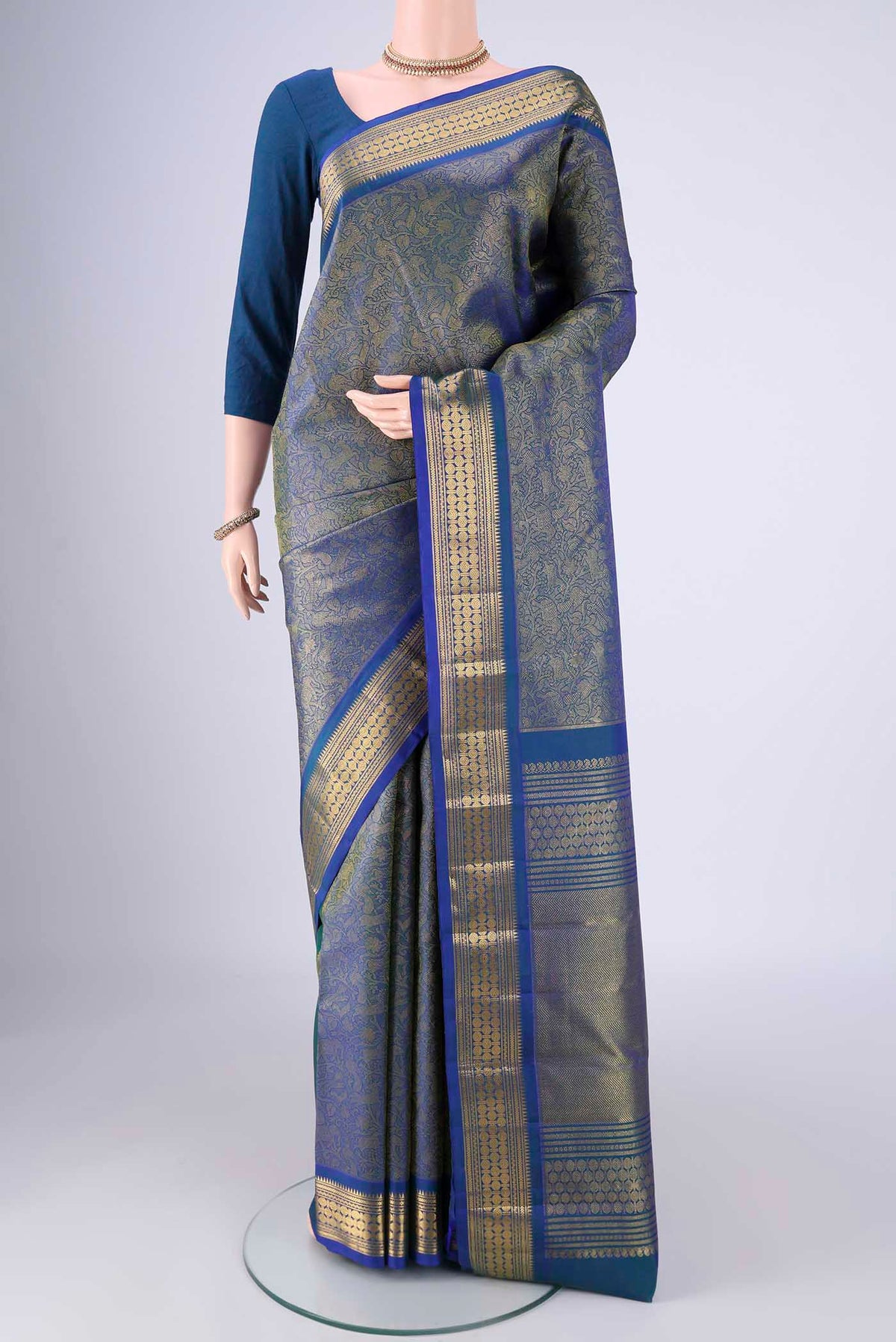 Pure Silk Pure Zari Blue Kanjivaram Saree with Zari Brocade on the body and Zari Border.  displayed on a mannequin