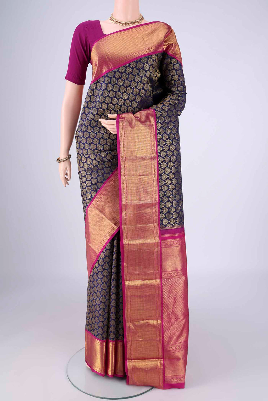 Navy Blue Kanjivaram Silk Saree with Zari Brocade on the body and Zari Border.  displayed on a mannequin