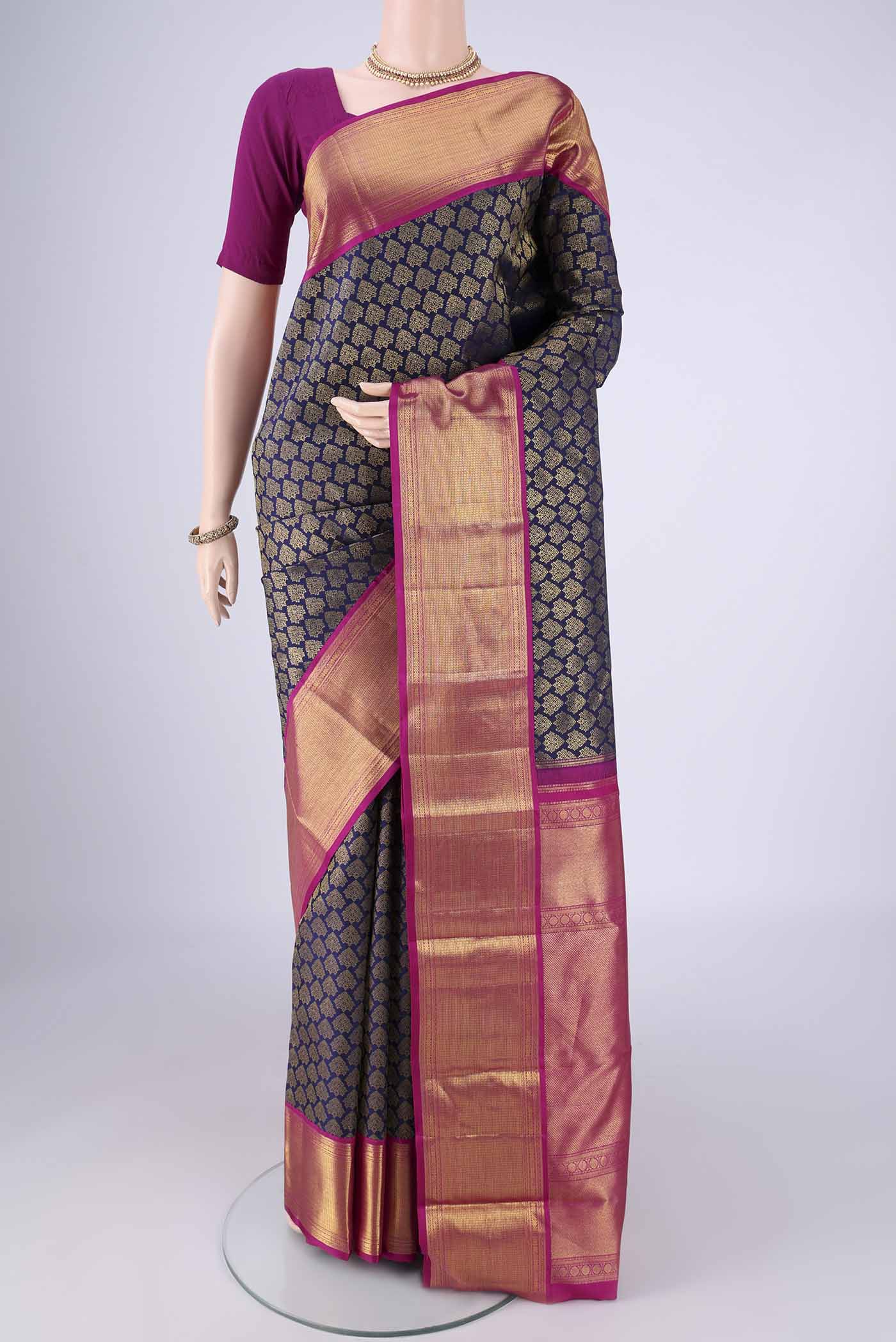 Navy Blue Kanjivaram Silk Saree with Zari Brocade on the body and Zari Border.  displayed on a mannequin