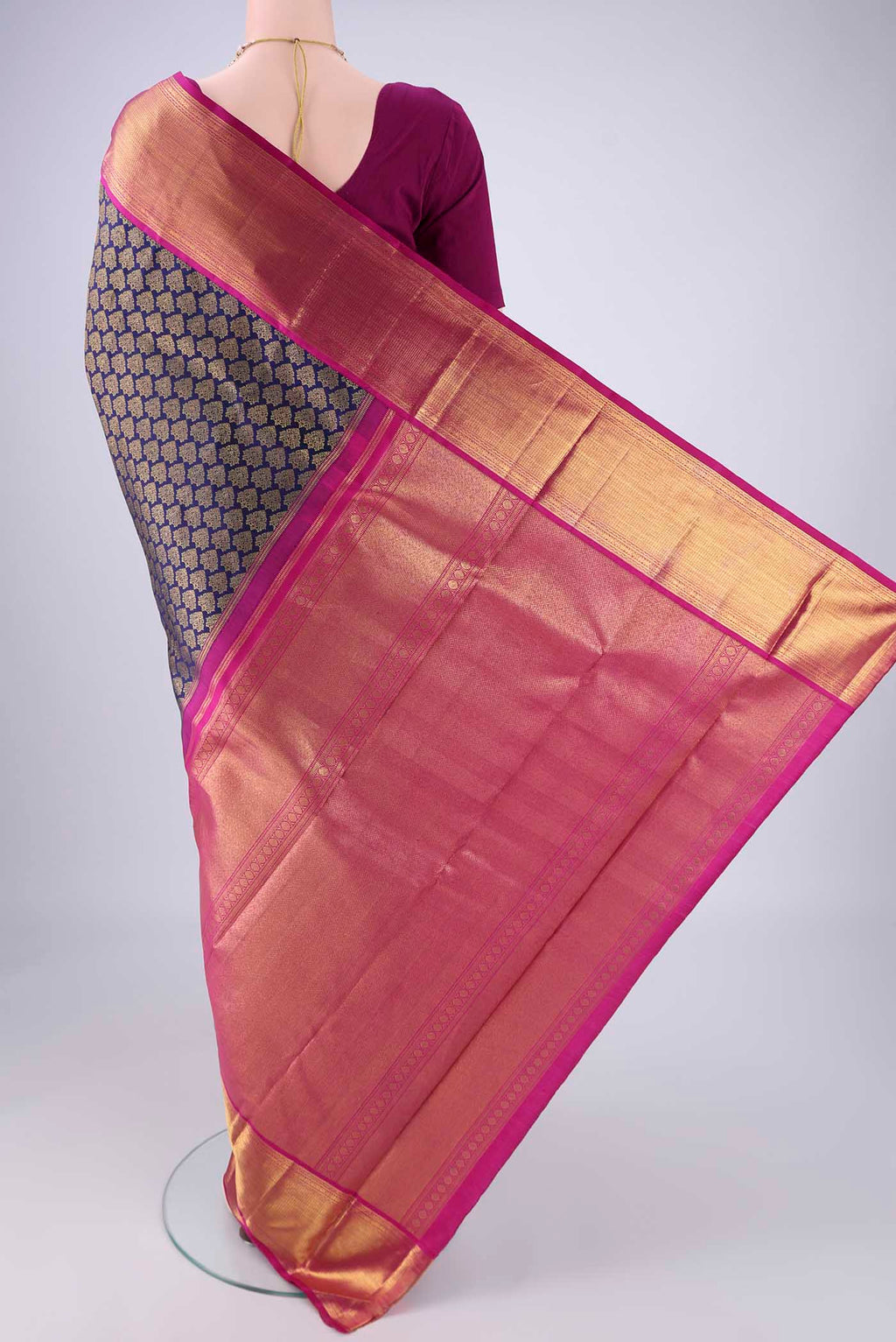 Flat view of Navy Blue Kanjivaram Silk Saree with Zari Brocade on the body and Zari Border. 