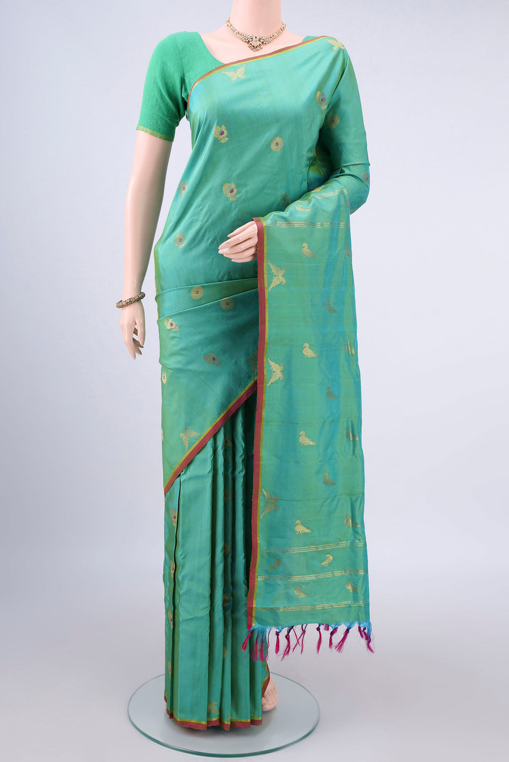 Pure Silk Sea Green Gadwal Saree with Zari Butta on the body and Without Border.  displayed on a mannequin