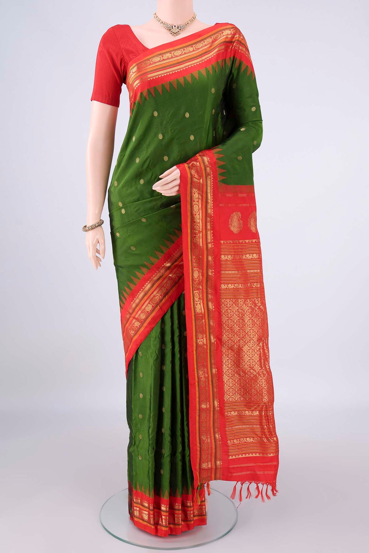 Pure Silk Green Gadwal Saree with Zari Butta on the body and Zari Border.  displayed on a mannequin