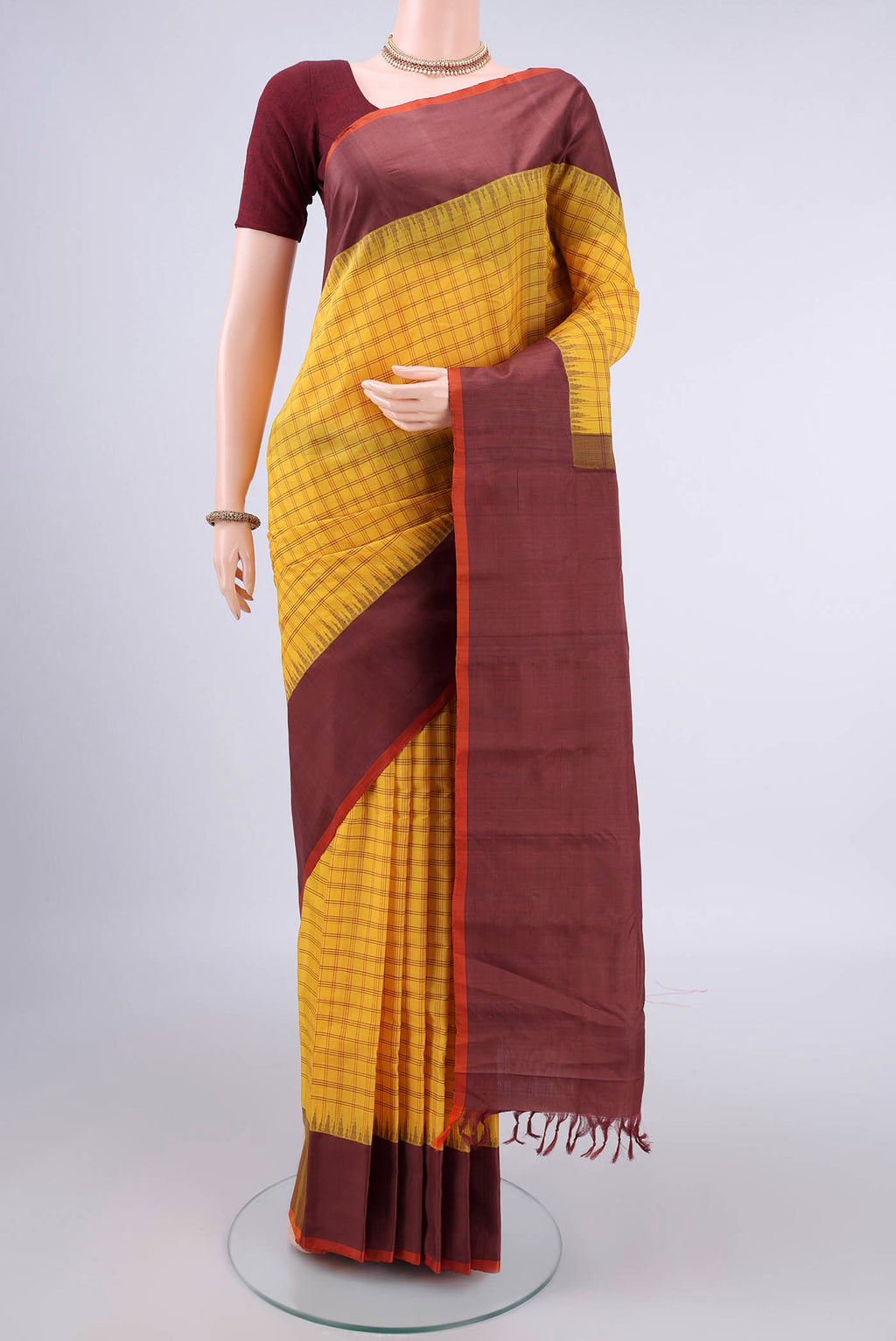 Yellow Gadwal Cotton Saree with Checked design on the body and Plain Border.  displayed on a mannequin