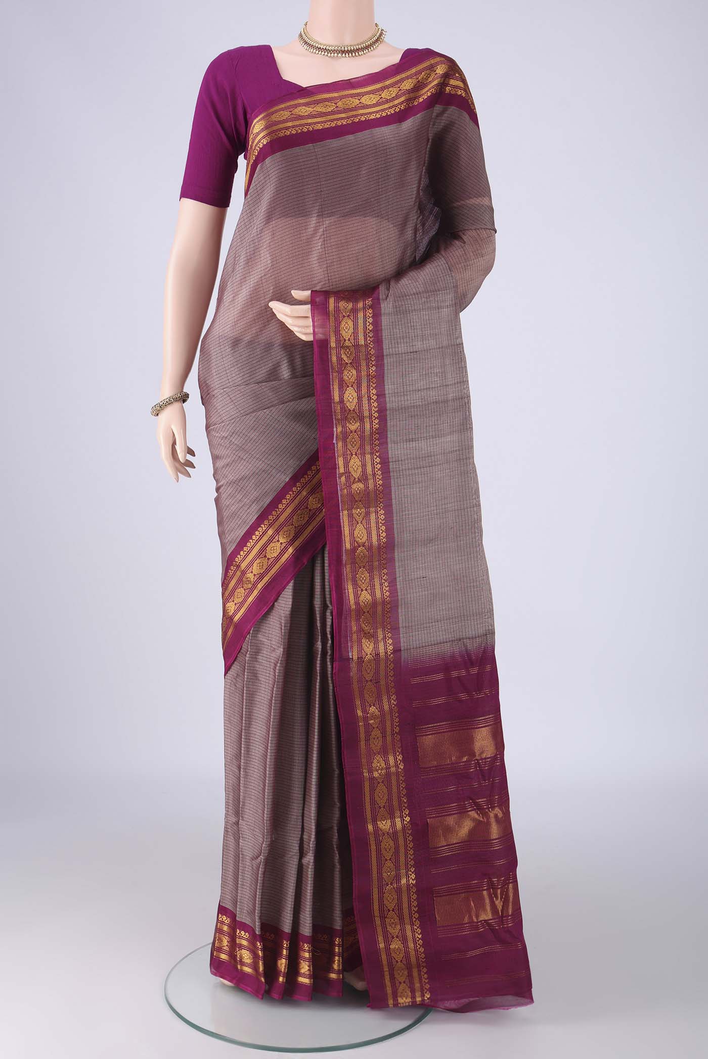 Grey Gadwal cotton Saree with Stripes on the body and Zari Border.  displayed on a mannequin