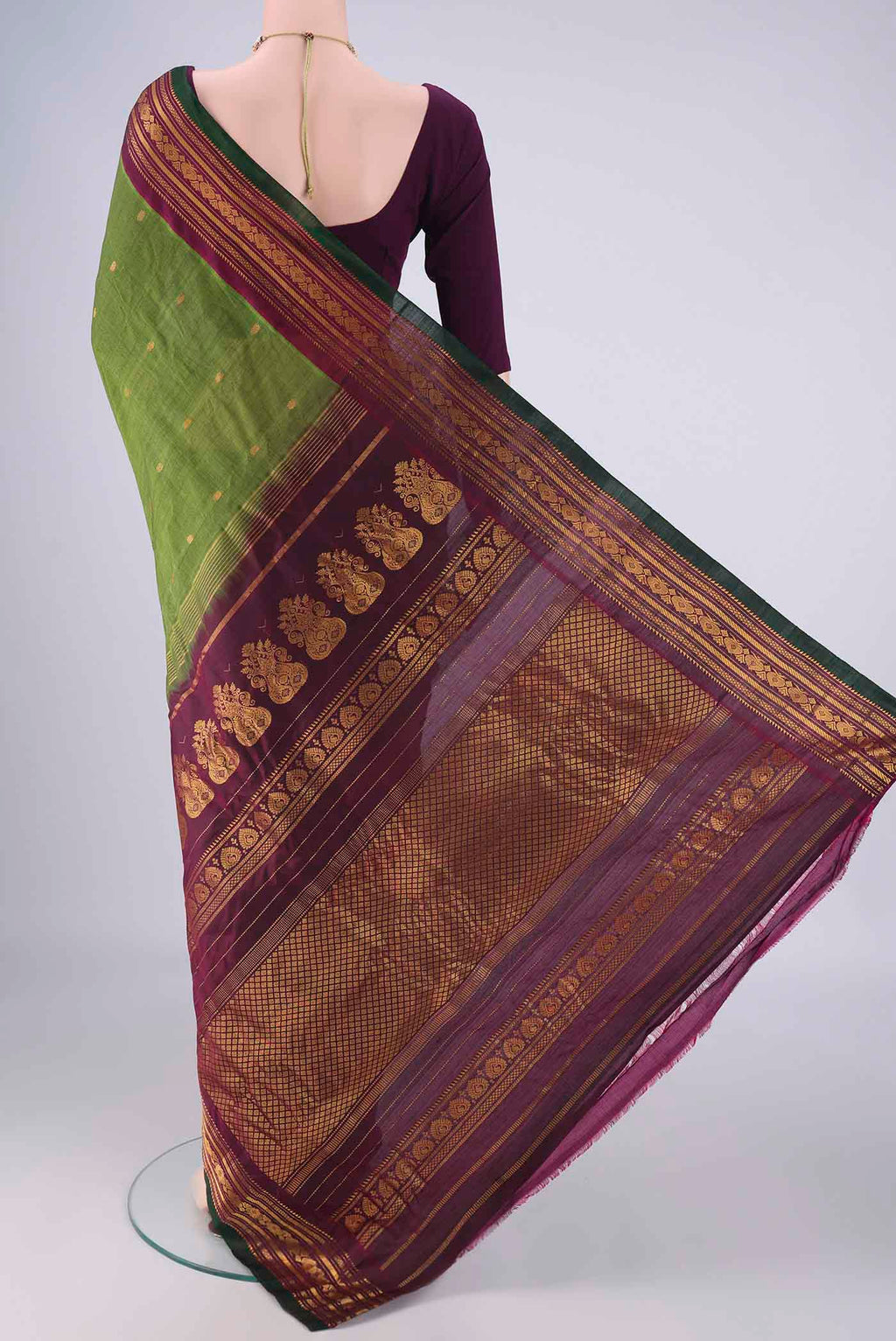 Flat view of Green Gadwal Silk Cotton Saree with Zari Butta on the body and Zari Border. 