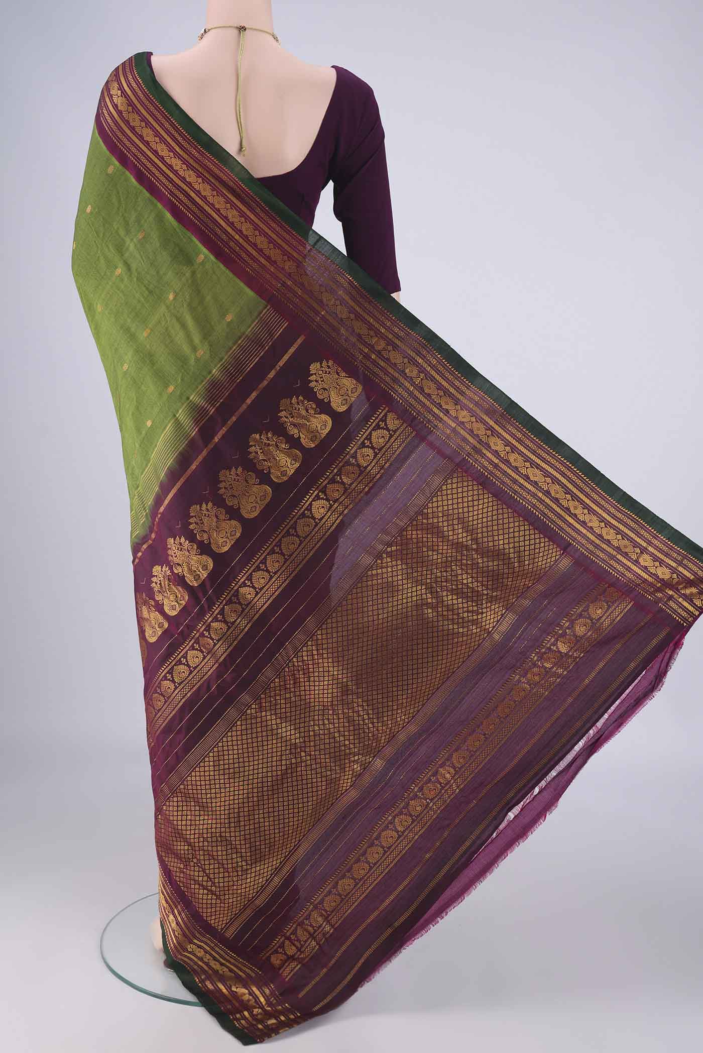 Flat view of Green Gadwal Silk Cotton Saree with Zari Butta on the body and Zari Border. 