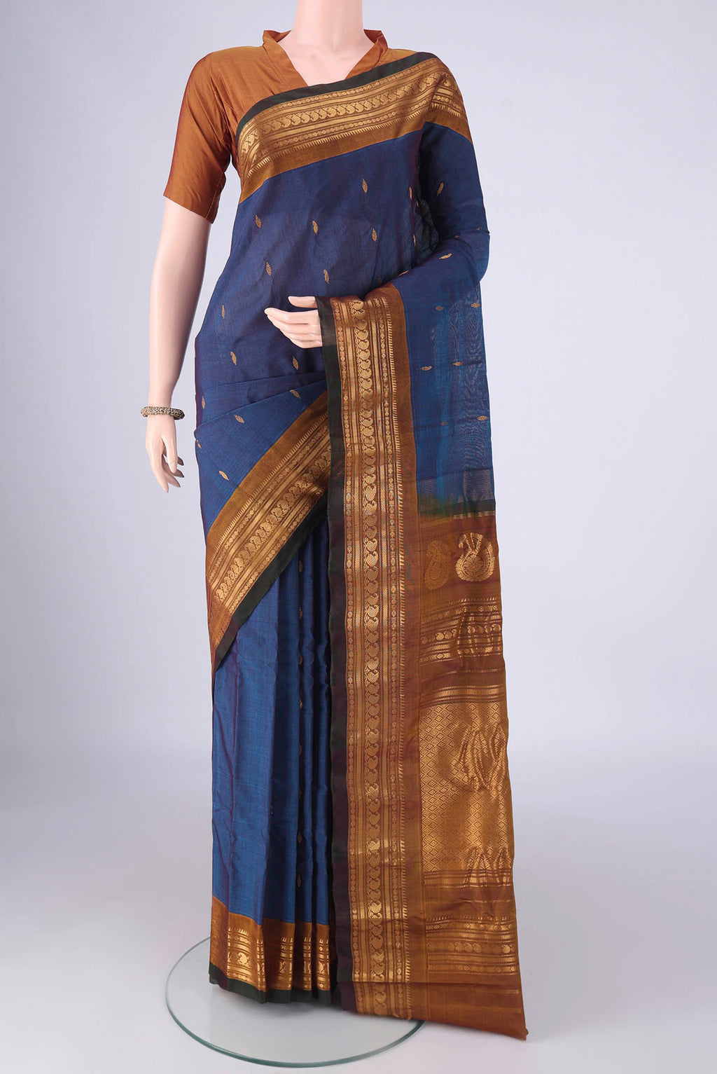 Blue Gadwal Silk Cotton Saree with Zari Butta on the body and Zari Border.  displayed on a mannequin