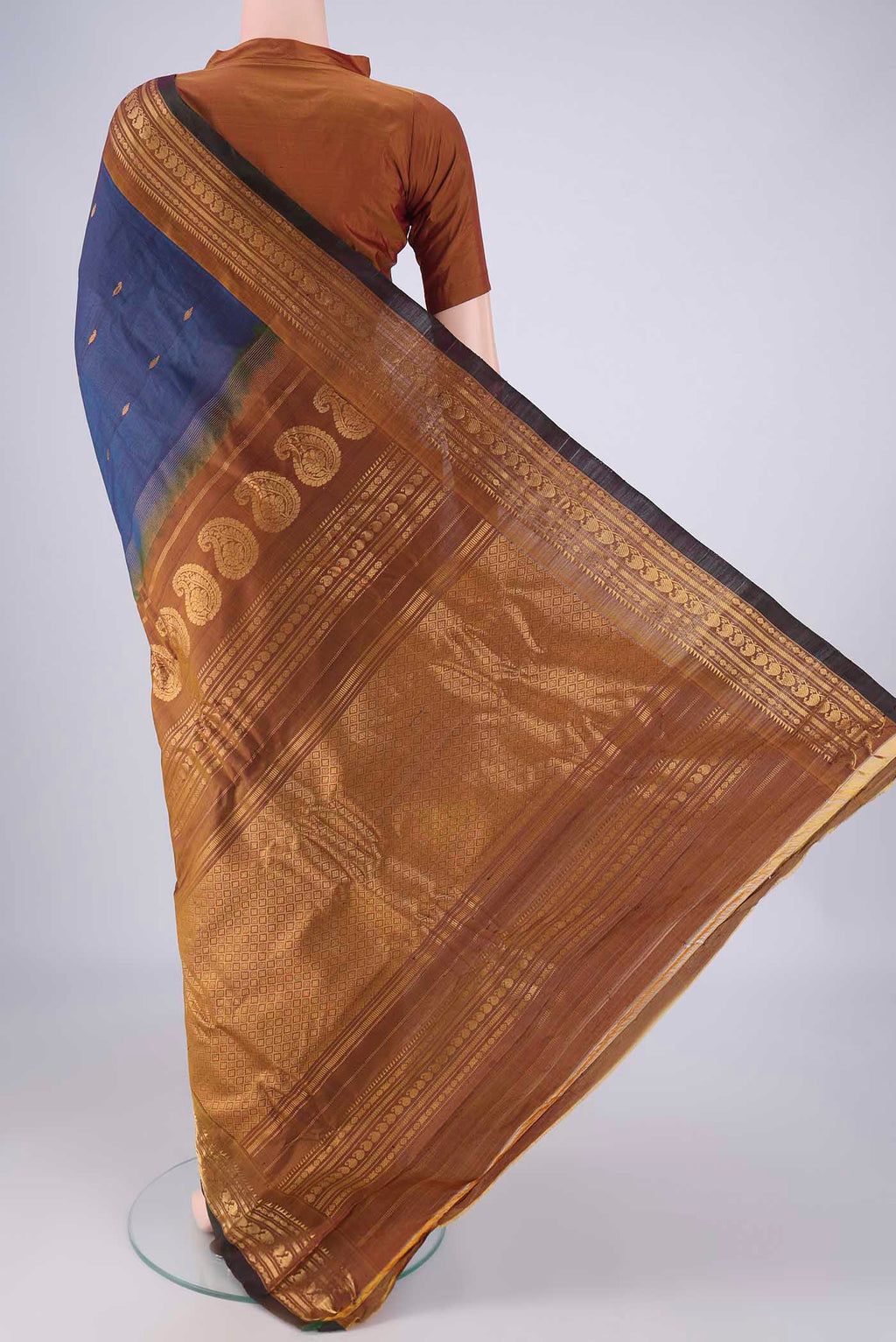 Flat view of Blue Gadwal Silk Cotton Saree with Zari Butta on the body and Zari Border. 