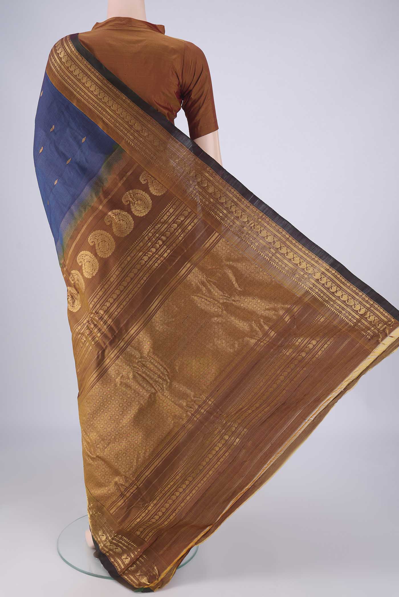 Flat view of Blue Gadwal Silk Cotton Saree with Zari Butta on the body and Zari Border. 
