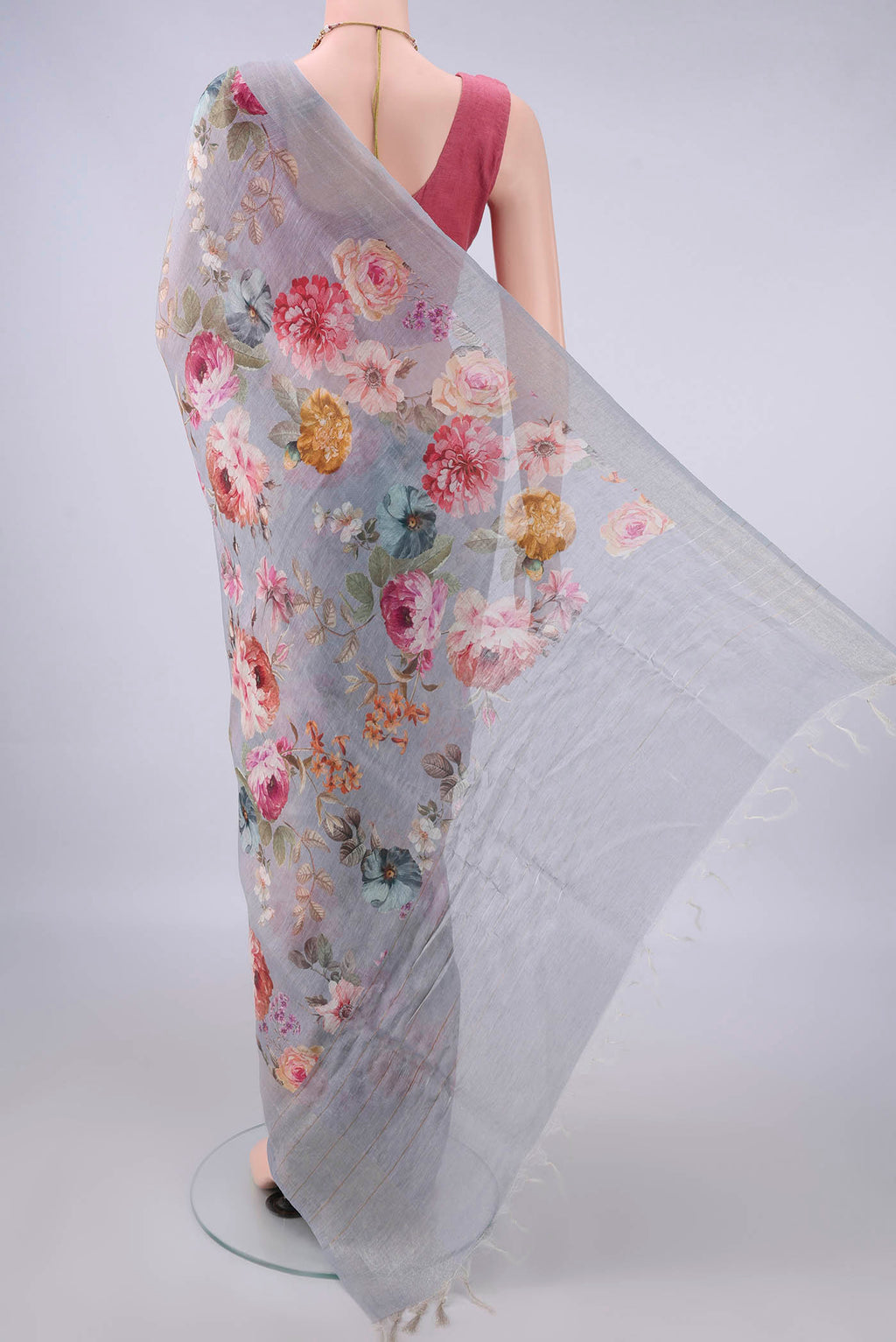 Flat view of Grey Linen Saree with Floral Print on the body and Zari Border. 