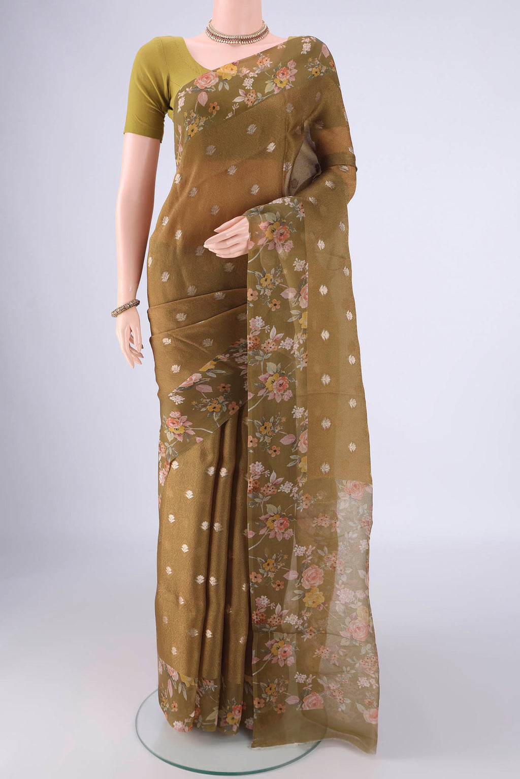 Mehandi Green Organza Silk Saree with Jacquard With Zari Butta on the body and Printed Border.  displayed on a mannequin