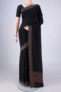 Black Mysore Crepe Saree with Plain Body and Printed Border.  displayed on a mannequin