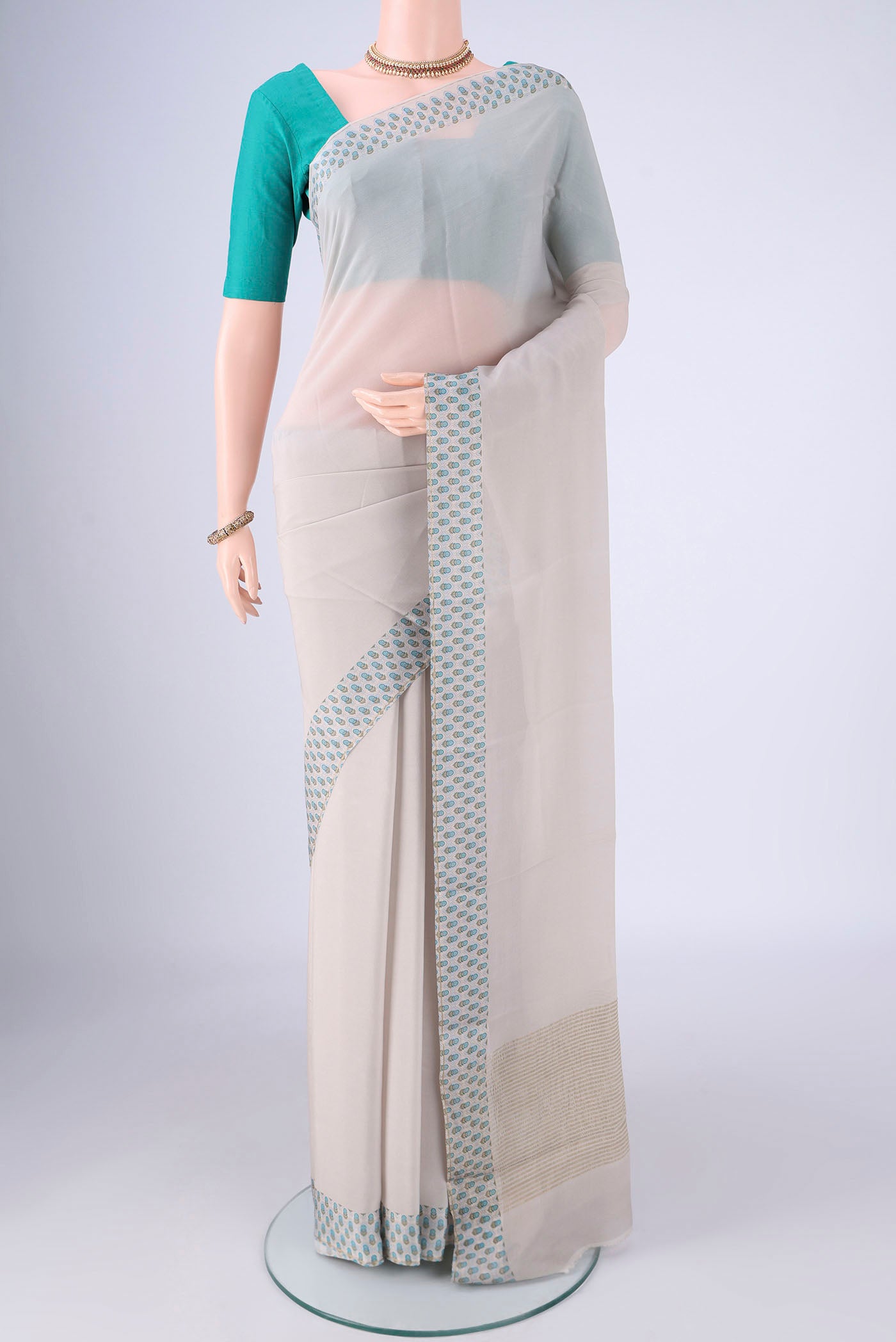 Grey Mysore Crepe Saree with Plain Body and Printed Border.  displayed on a mannequin