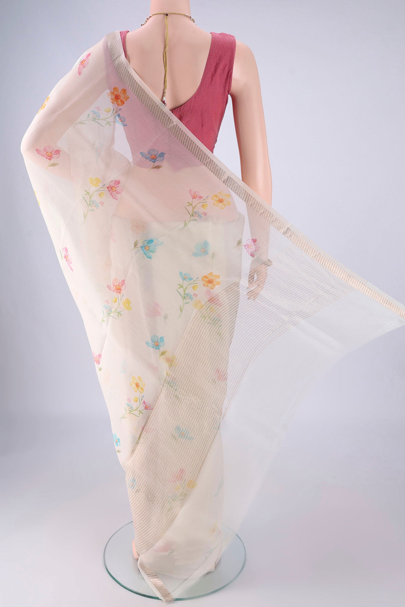 Flat view of Off White Organza Silk Saree with Floral Print on the body and Zari Border. 