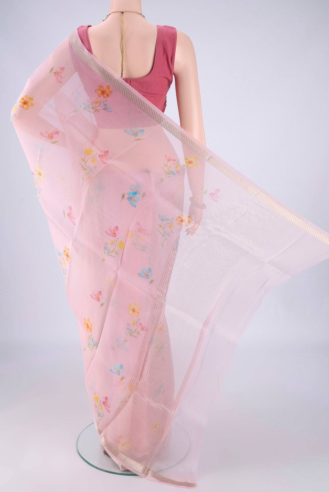 Flat view of Rose pink Organza Silk Saree with Printed design on the body and Zari Border. 