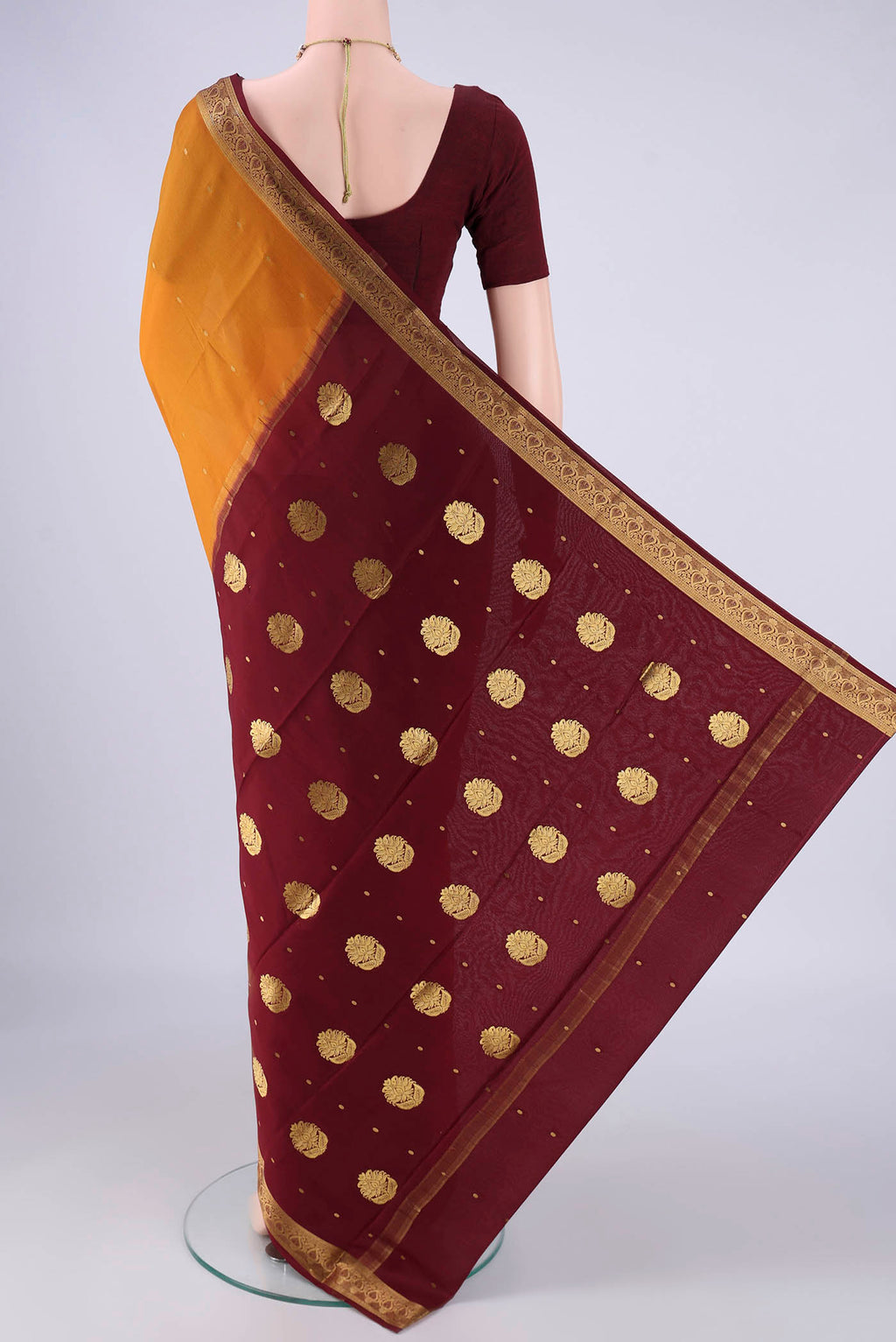 Flat view of Mustard Mysore Crepe Saree with Zari Butta on the body and Zari Border. 