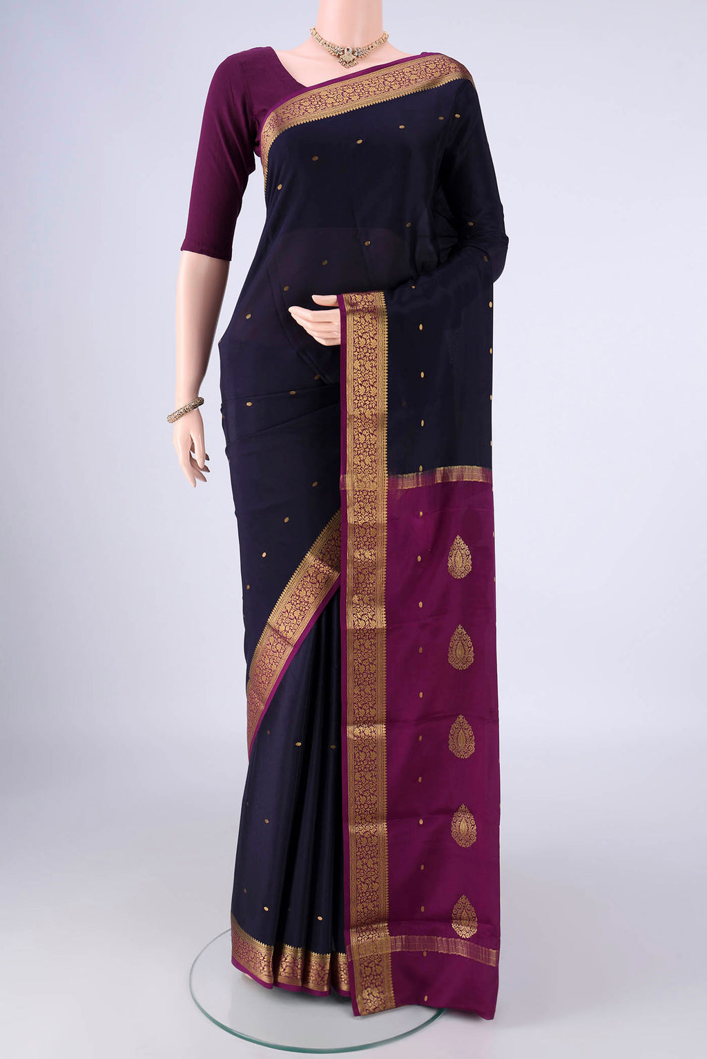 Navy Blue Mysore Crepe Saree with Zari Butta on the body and Zari Border.  displayed on a mannequin